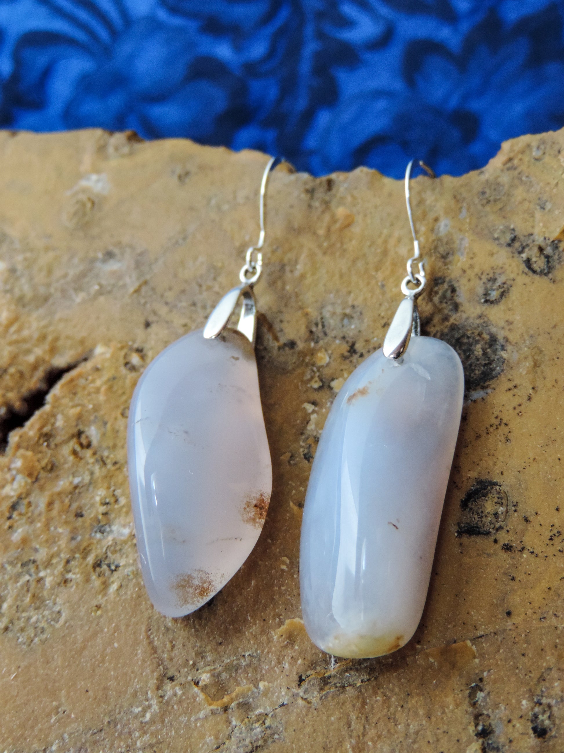 The bail and earring wires are authentic 925 sterling silver.  Wear these original earrings and stand out in a crowd!  Known as the Treasure State, Montana’s landscape is an abundant resource for precious and semi-precious stones.  One of the semi-precious stones, Madison Blue Agate, are featured in these earrings.