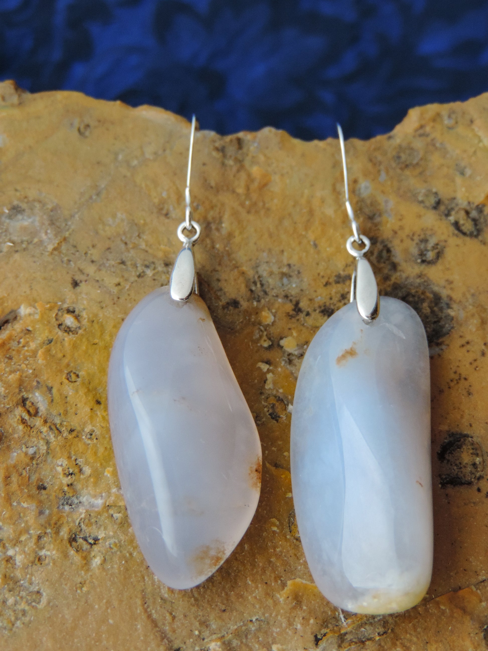 The bail and earring wires are authentic 925 sterling silver.  Wear these original earrings and stand out in a crowd!  Known as the Treasure State, Montana’s landscape is an abundant resource for precious and semi-precious stones.  One of the semi-precious stones, Madison Blue Agate, are featured in these earrings.