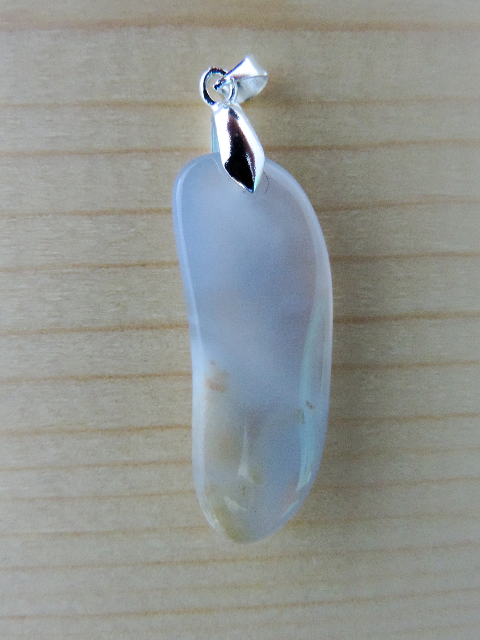 This rare stone is found in only a few locations in Montana, our material is hand collected on private property in the mountains and carried out in backpacks...each piece worth its weight in every step!  The translucent blue agate and its color variations have an alluring effect, many people find the blue agate a relaxing, calming and peaceful stone to wear.  Original and unique in design, each piece is hand crafted by lapidary artists in Montana.