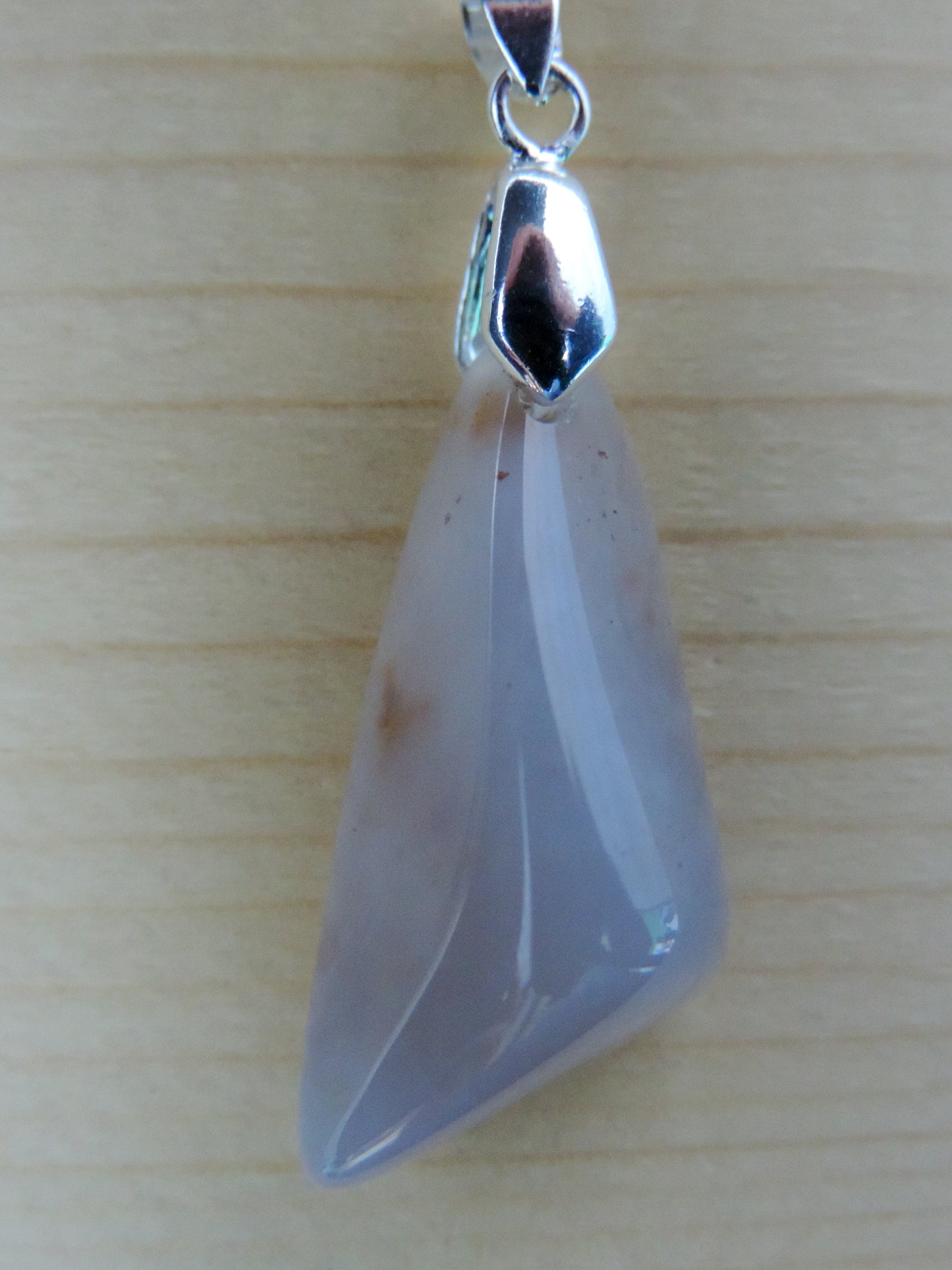 This rare stone is found in only a few locations in Montana, our material is hand collected on private property in the mountains and carried out in backpacks...each piece worth its weight in every step!  The translucent blue agate and its color variations have an alluring effect, many people find the blue agate a relaxing, calming and peaceful stone to wear.  Original and unique in design, each piece is hand crafted by lapidary artists in Montana.