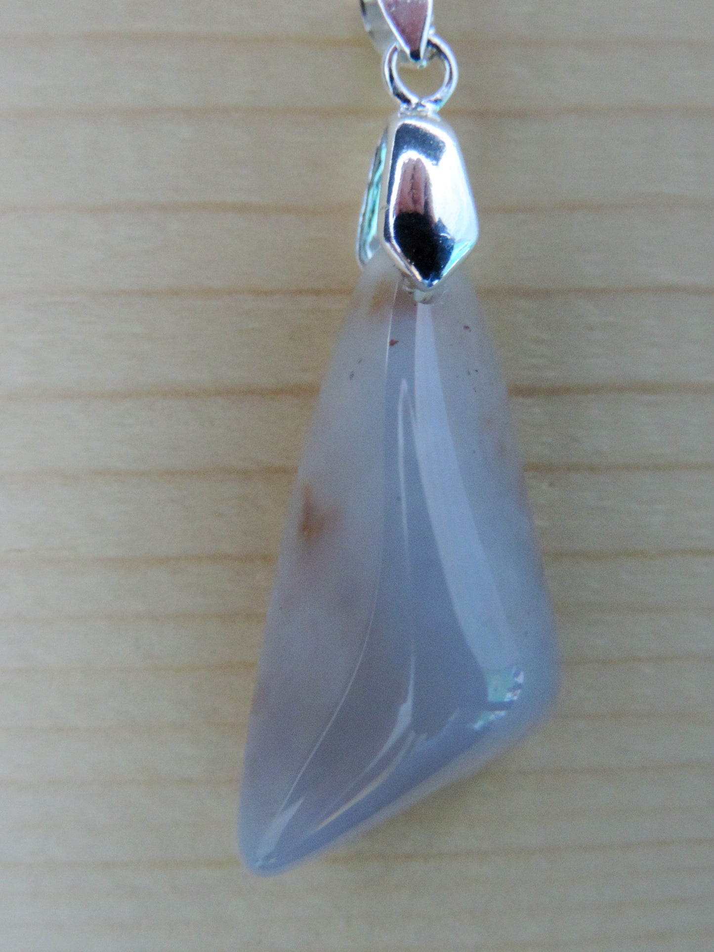 This rare stone is found in only a few locations in Montana, our material is hand collected on private property in the mountains and carried out in backpacks...each piece worth its weight in every step!  The translucent blue agate and its color variations have an alluring effect, many people find the blue agate a relaxing, calming and peaceful stone to wear.  Original and unique in design, each piece is hand crafted by lapidary artists in Montana.