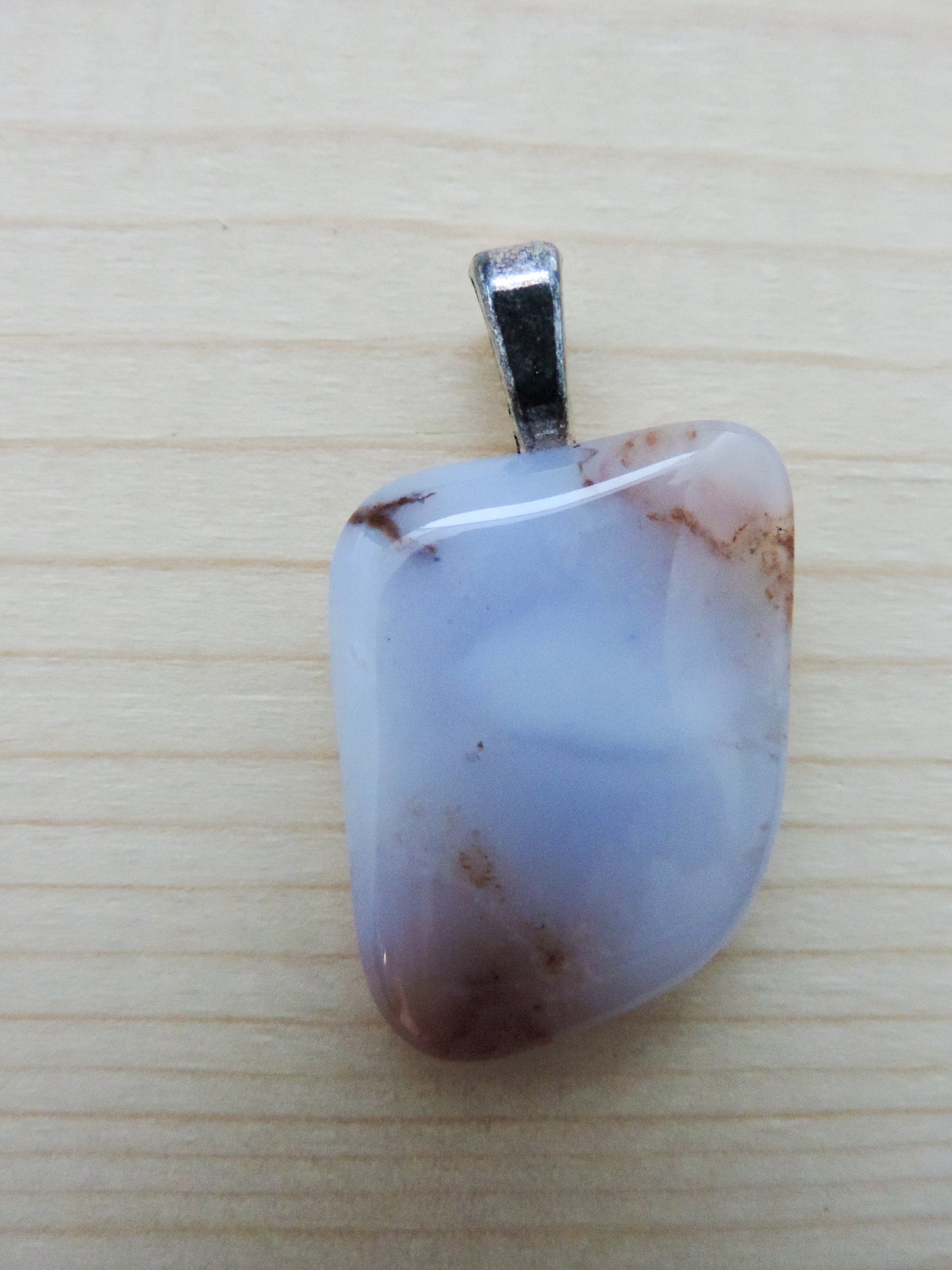 Montana Madison Blue Agate Pendant. The stone in this pendant is a unique result of tumble shaping and polishing a piece of agate from its natural state. This one of a kind Montana Madison Blue Agate Pendant will show off your unique taste!
