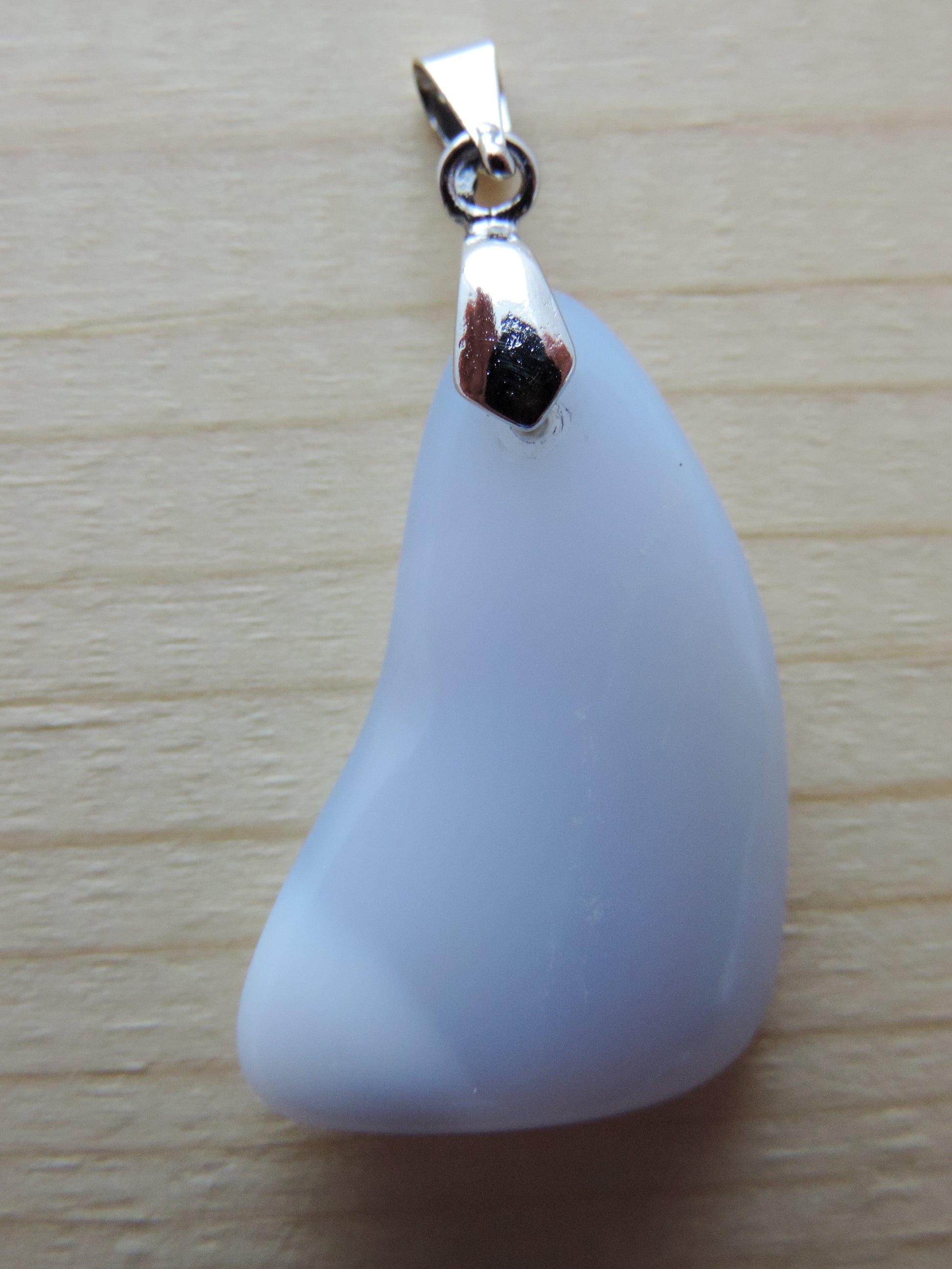 Montana Madison Blue Agate Pendant.  The stone in this pendant is a unique result of tumble shaping and polishing a piece of agate from its natural state.  The pendant is reversible, allowing you to present its natural beauty from either side to be admired by all.  This one of a kind pendant will show off your unique taste!