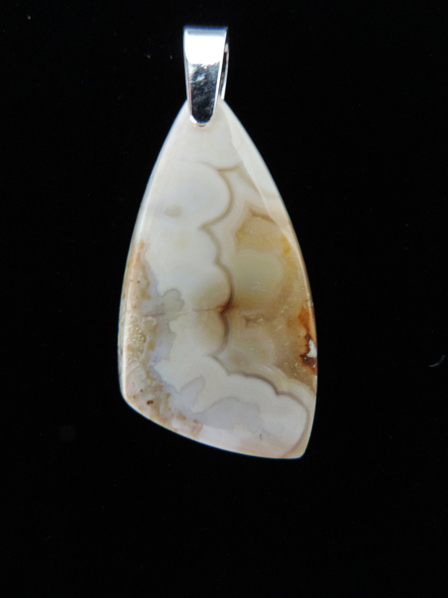 Brown Lace Agate pendant from West Sumatra. Brown Lace Agate from West Sumatra.  Indonesian Agates exhibit a wide variety of colors and amazing complexity.  No two agates are exactly alike, each one being a unique and beautiful creation! The pendant bail is authentic 925 sterling silver.     Our hand crafted jewelry is photographed next to a ruler for size.  This stone is a natural color, no dyes or heat treatment have been used. 