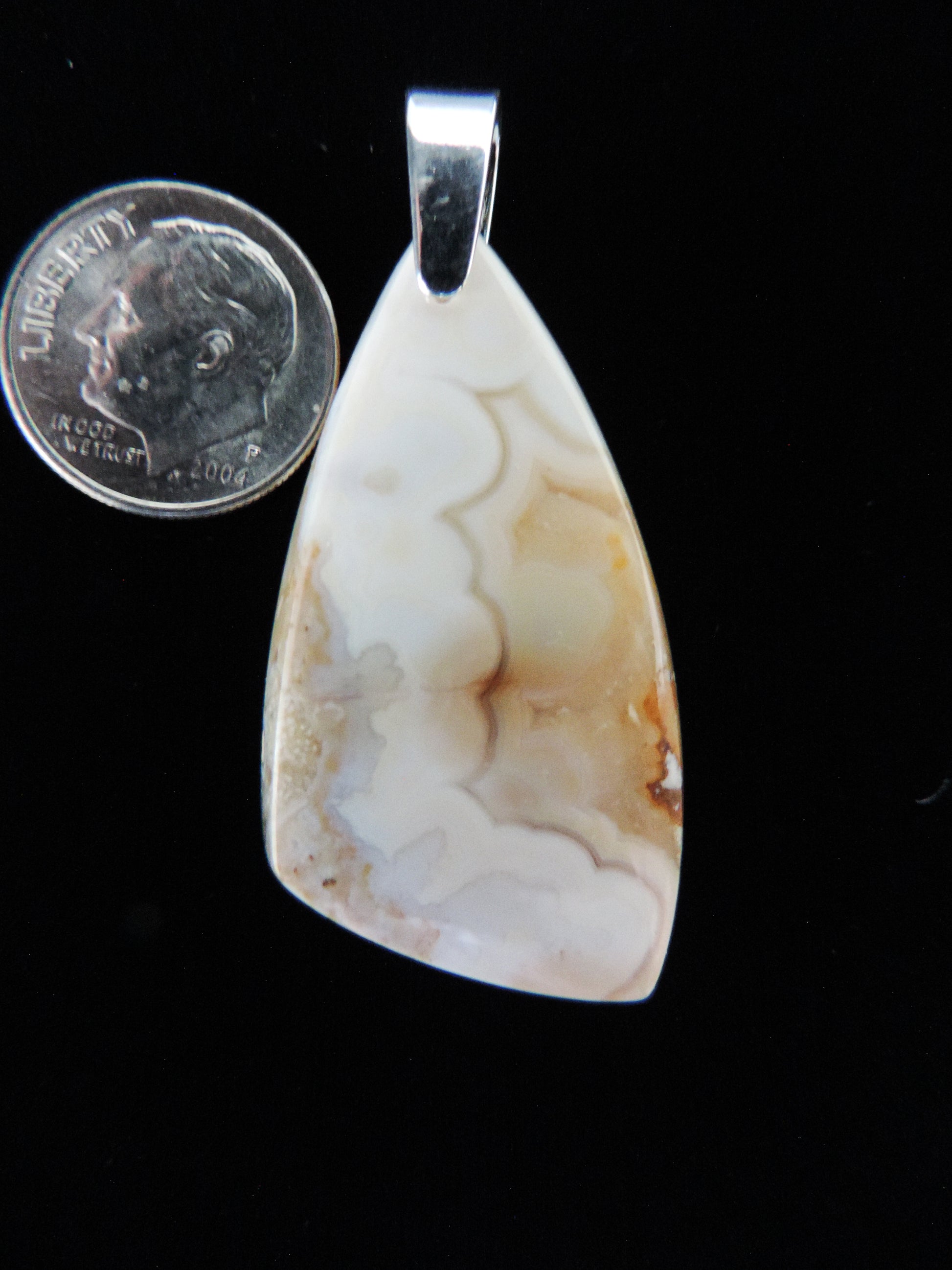 Brown Lace Agate from West Sumatra.  Indonesian Agates exhibit a wide variety of colors and amazing complexity.  No two agates are exactly alike, each one being a unique and beautiful creation! The pendant bail is authentic 925 sterling silver.     Our hand crafted jewelry is photographed next to a ruler for size.  This stone is a natural color, no dyes or heat treatment have been used. 