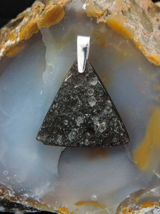 Agni Manitite and Sterling Silver Pendant.  The Agni Manitite pendants on our store are unique in design.  One side is smooth and polished while the other side looks rough and irregular, a representation of its natural state.  