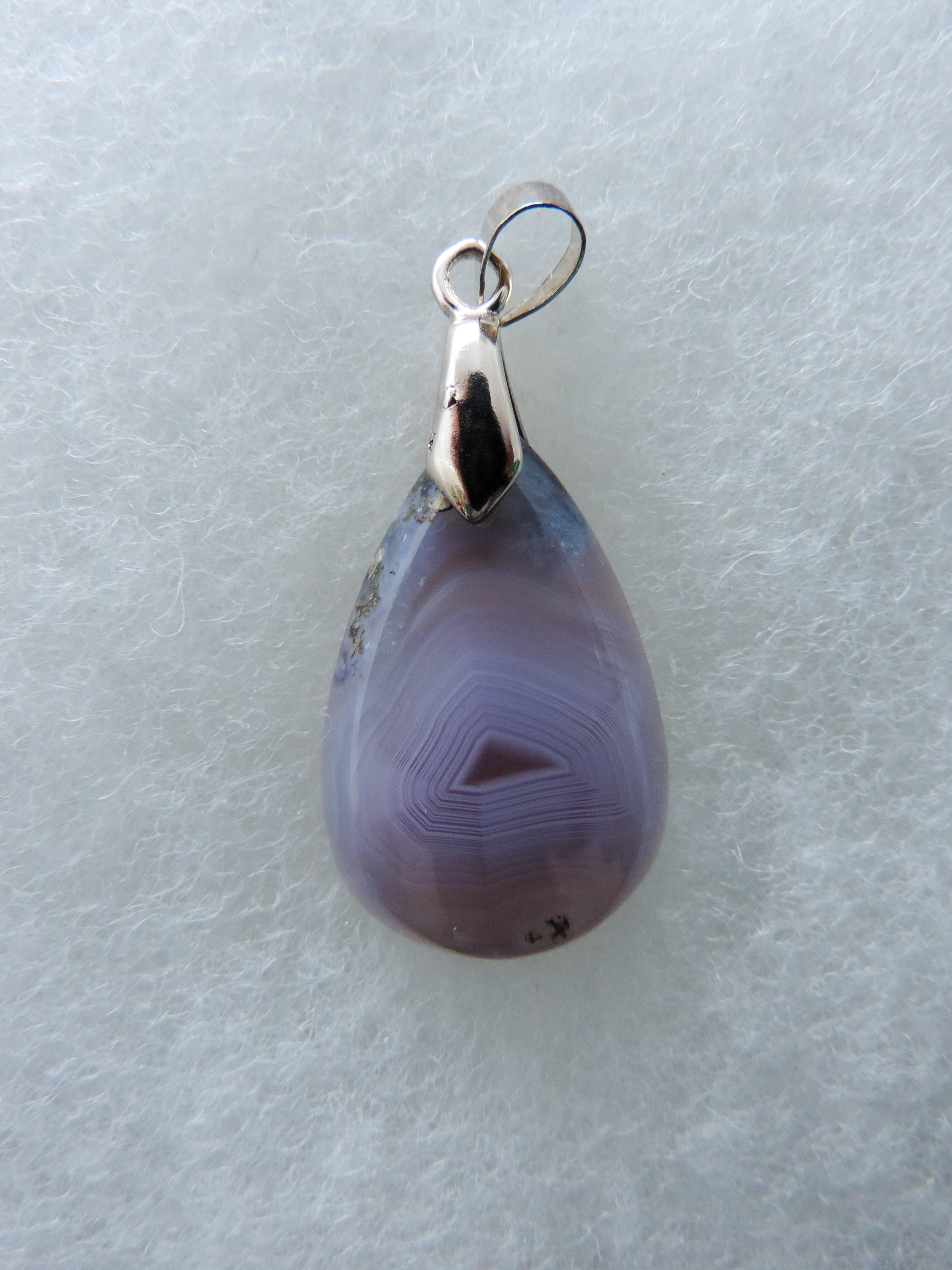 Wear a purple moss agate pendant today!  Our hand crafted jewelry pendant is photographed next to a ruler for size.  This stone is a natural color, no dyes or heat treatment have been used.