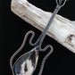 Show off your unique taste with this palm root guitar pendant!