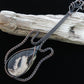 Like other fossilized materials, petrified Palm Root represents one of the many wonders of ancient Earth!    Show off your unique taste with this palm root guitar pendant!