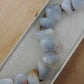 The stones in this bracelet are a unique result of tumble shaping and polishing agate from its natural state.  This one of kind bracelet will show off your unique taste!  Known as the Treasure State, Montana’s landscape is an abundant resource for precious and semi-precious stones.  One of the semi-precious stones, Madison Blue Agate, is featured in this bracelet.  This rare stone is found in only a few locations in Montana