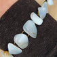 The stones in this bracelet are a unique result of tumble shaping and polishing agate from its natural state.  This one of kind bracelet will show off your unique taste!  Known as the Treasure State, Montana’s landscape is an abundant resource for precious and semi-precious stones.  One of the semi-precious stones, Madison Blue Agate, is featured in this bracelet.  This rare stone is found in only a few locations in Montana