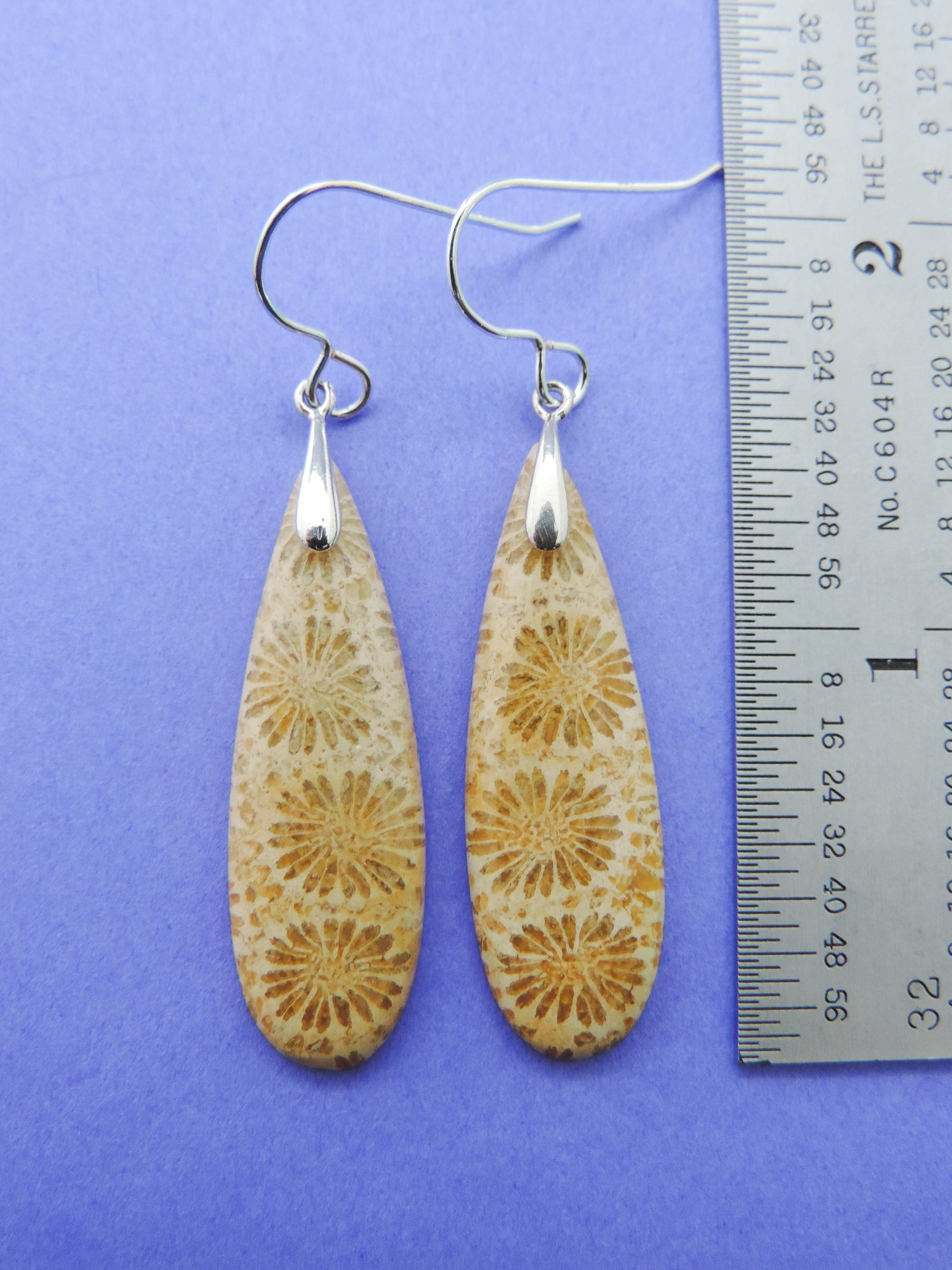 Our hand crafted jewelry earrings are photographed next to a ruler for size.  This stone is a natural color, no dyes or heat treatment have been used.  It was photographed without filters on automatic setting in natural light; however, slight color variations may occur due to digitization