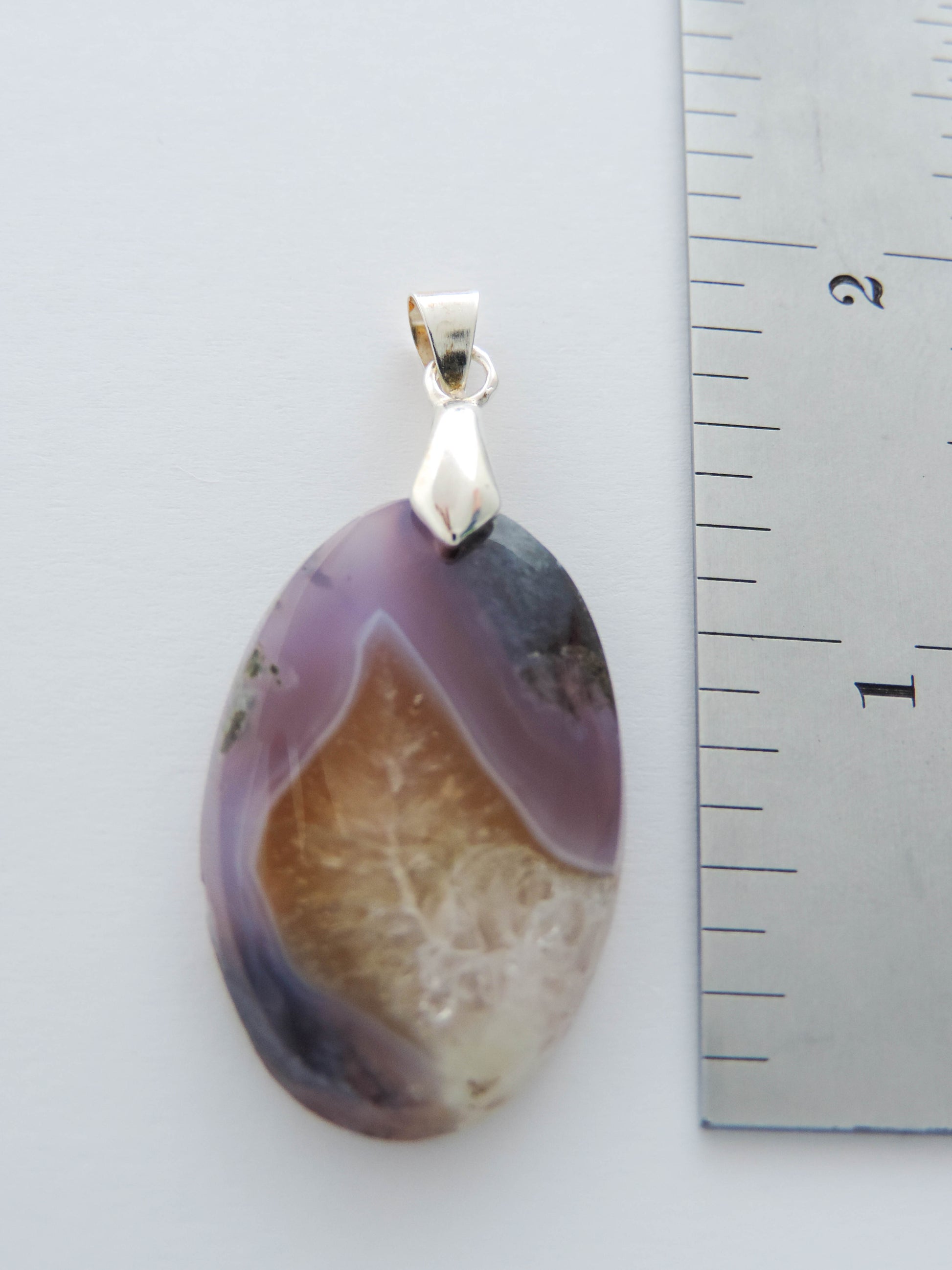 Throughout history, the spiritual meanings and properties of purple gemstones have always been positive as they were known to bring forth the purest aspirations of human kind.  The purple gemstones on this store come from Java, Indonesia.  Wear a Purple Moss Agate Pendant today!  Our hand crafted jewelry pendant is