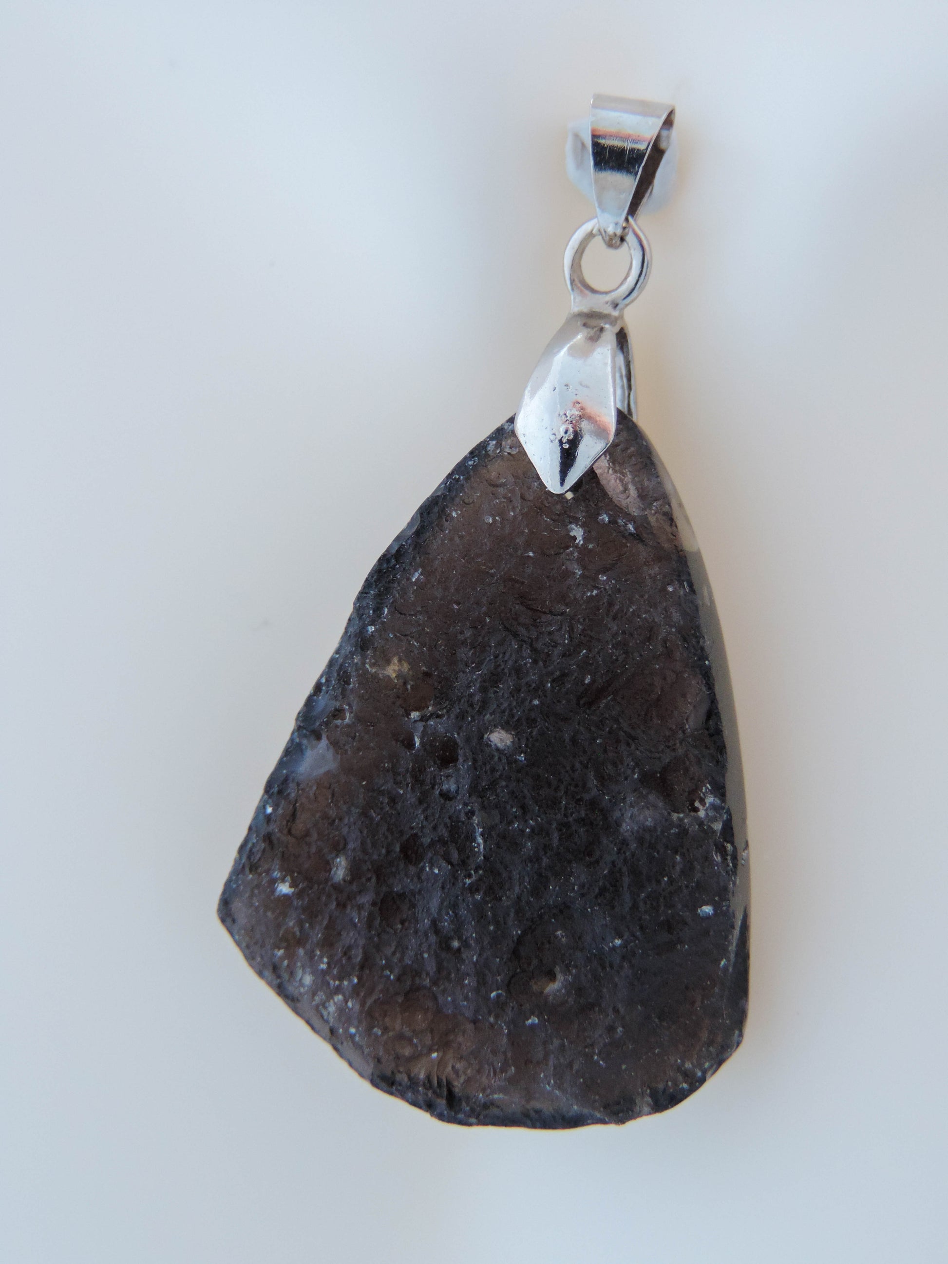 The Agni Manitite pendants on our store are unique in design.  One side is smooth and polished while the other side looks rough and irregular,