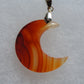 Carnelian Moon Pendant.  Indonesian Agates exhibit a wide variety of colors and amazing complexity.  No two agates are exactly alike, each one being a unique and beautiful creation!  Agates with multiple bands of color are known as fortification agates, those with dendritic or moss looking inclusions are referred to as moss agate and many others are given descriptive names relative to their appearance or where they are found. 