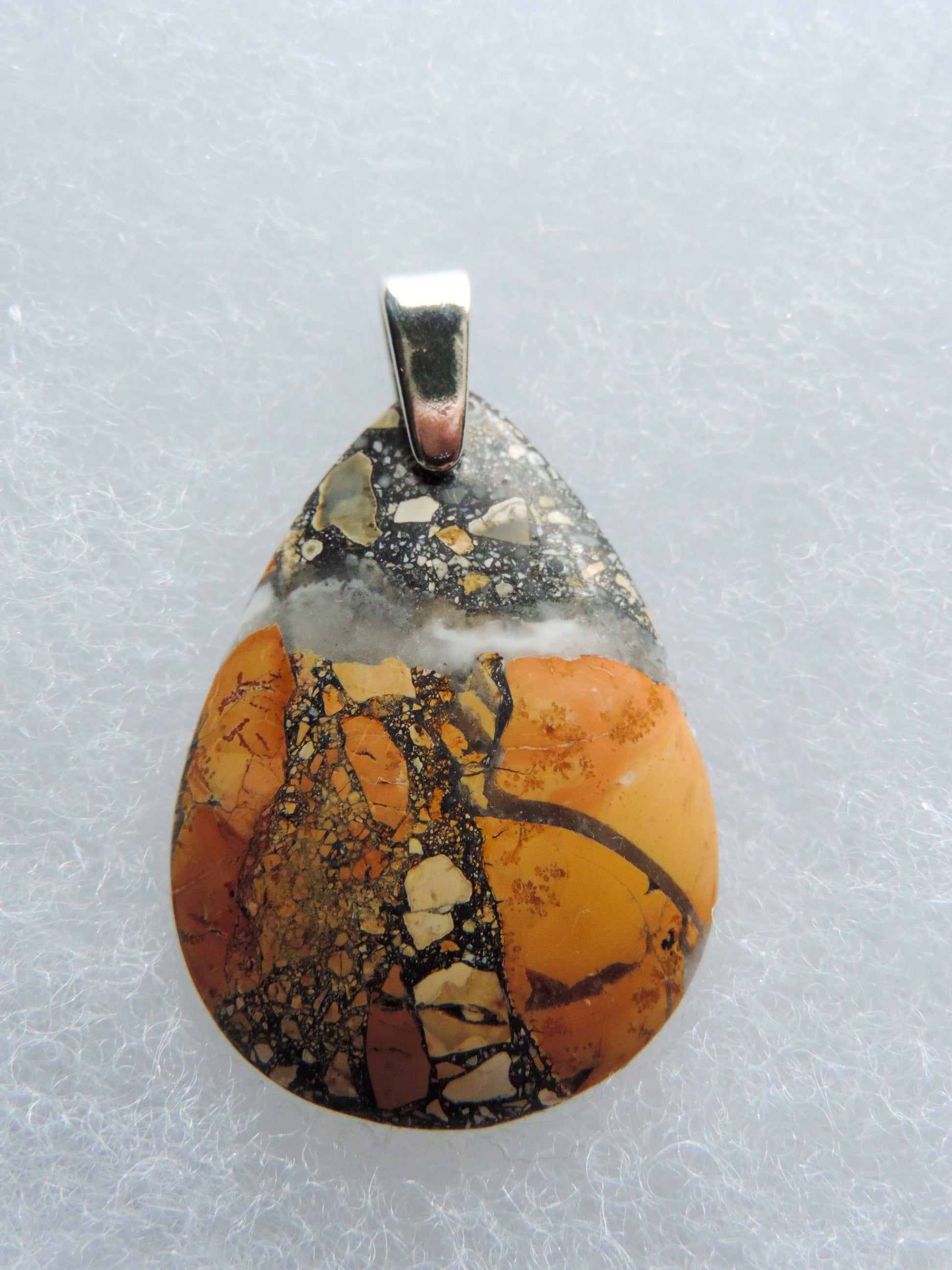 Exquisite in appearance, this Maligano Jasper & Sterling Silver Pendant will compliment your formal or casual attire.   The pendant bail is authentic 925 sterling silver.   Our hand crafted jewelry pendant is photographed next to a ruler for size.  