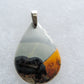 Exquisite in appearance, this Maligano Jasper & Sterling Silver Pendant will compliment your formal or casual attire.   The pendant bail is authentic 925 sterling silver. 