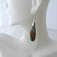 The bail and earring wires are authentic 925 sterling silver.  Feel treasured when you wear these earrings!Extremely rare and lovely, Indonesian Blue Opalized Wood is a cherished material used by lapidary artists for creating stunning pieces of jewelry.  The material was first found as pebbles and rounded stones in streams and near the slopes of three volcanoes in the West Java Province.  
