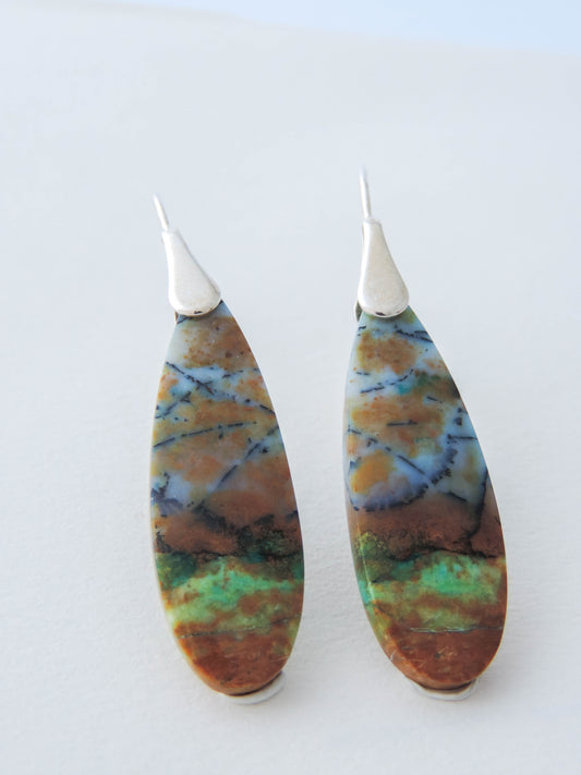 Extremely rare and lovely, Indonesian Blue Opalized Wood is a cherished material used by lapidary artists for creating stunning pieces of jewelry.  The material was first found as pebbles and rounded stones in streams and near the slopes of three volcanoes in the West Java Province. The bail and earring wires are authentic 925 sterling silver.  Feel treasured when you wear these earrings!