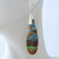 Extremely rare and lovely, Indonesian Blue Opalized Wood is a cherished material used by lapidary artists for creating stunning pieces of jewelry.  The material was first found as pebbles and rounded stones in streams and near the slopes of three volcanoes in the West Java Province. The bail and earring wires are authentic 925 sterling silver.  Feel treasured when you wear these earrings!