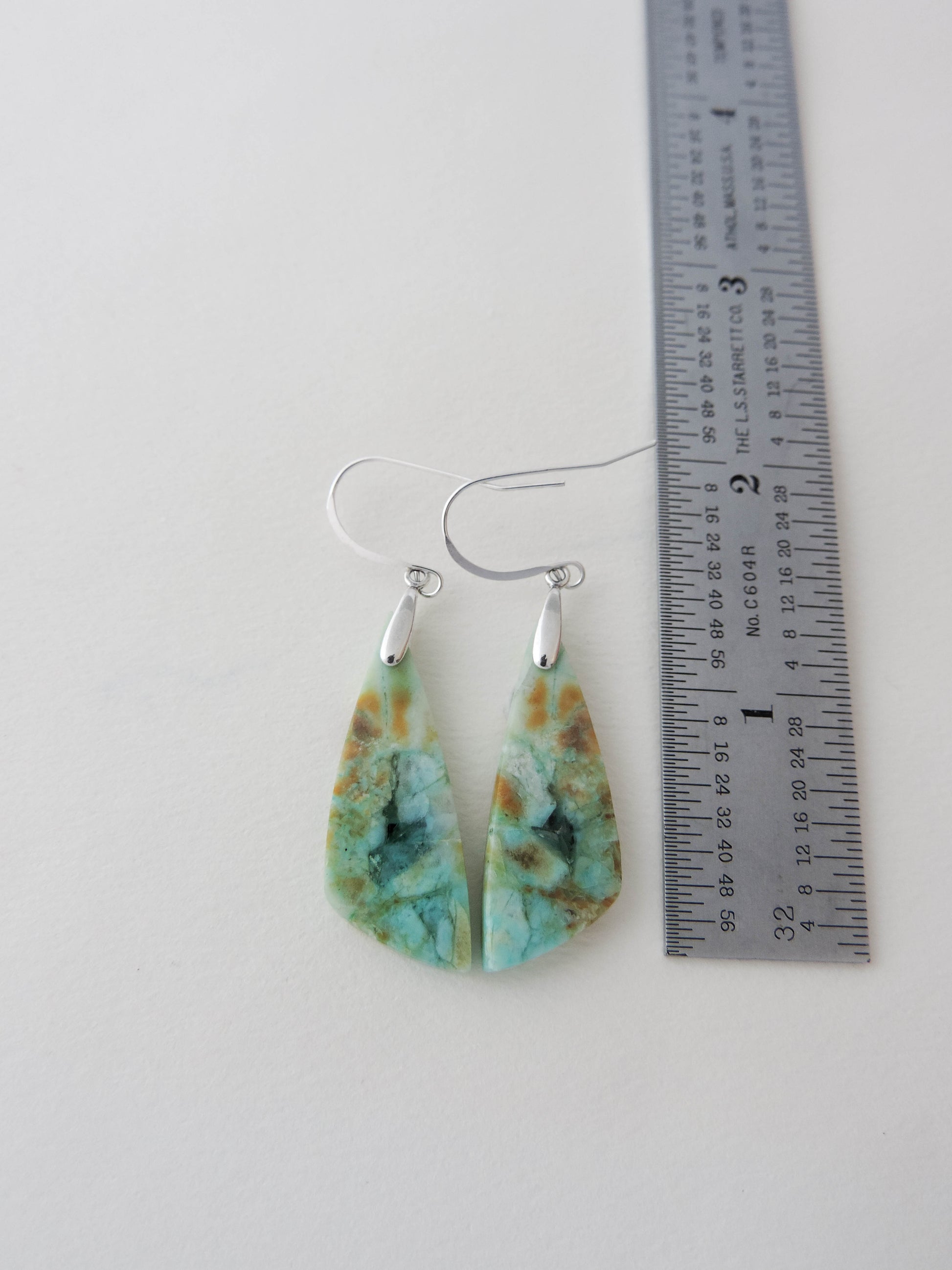 Extremely rare and lovely, Indonesian Blue Opalized Wood is a cherished material used by lapidary artists for creating stunning pieces of jewelry.  The material was first found as pebbles and rounded stones in streams and near the slopes of three volcanoes in the West Java Province. Indonesian Blue Opalized Wood Earrings with Sterling Silver.