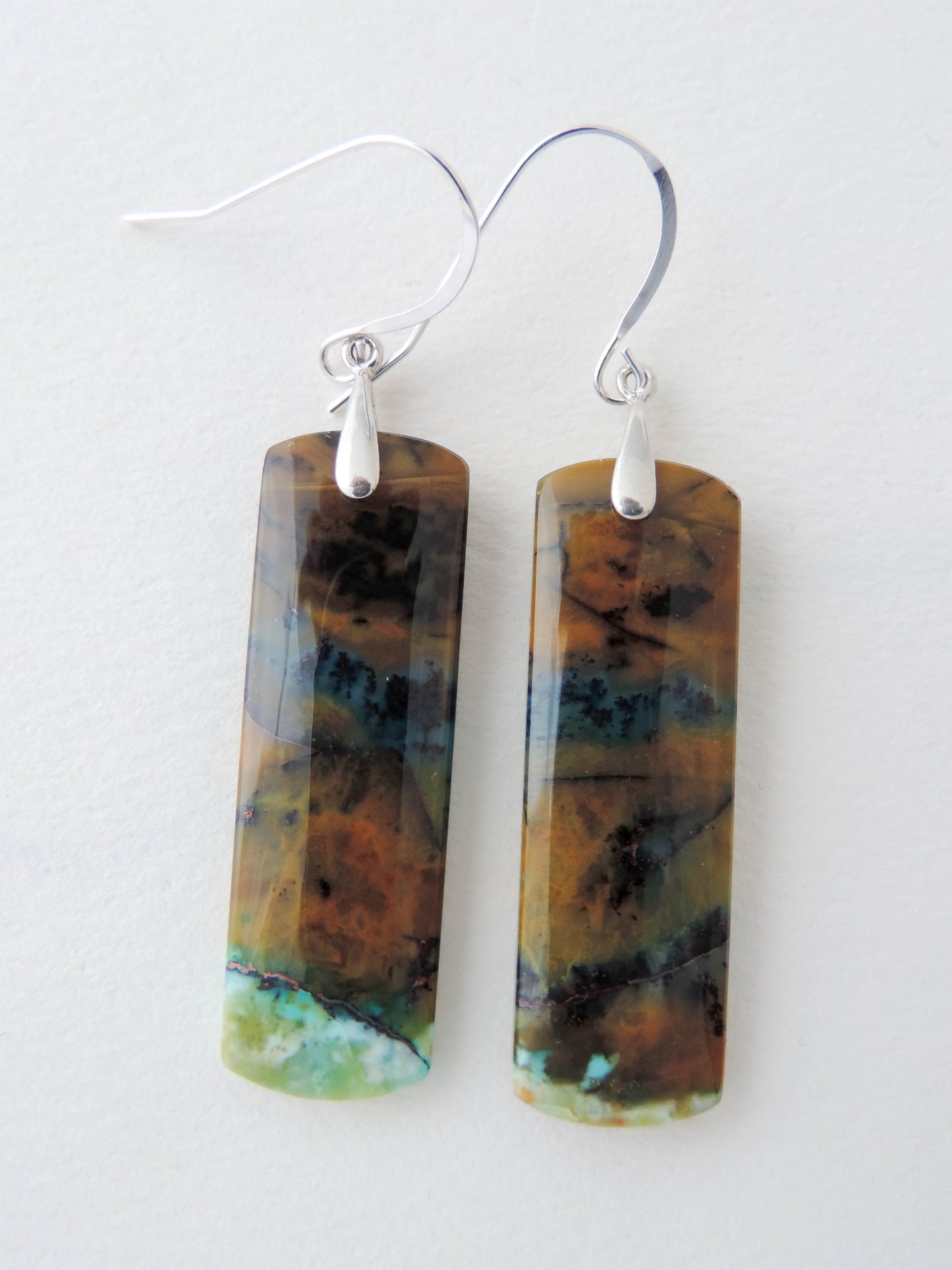 Extremely rare and lovely, Indonesian Blue Opalized Wood is a cherished material used by lapidary artists for creating stunning pieces of jewelry.  The material was first found as pebbles and rounded stones in streams and near the slopes of three volcanoes in the West Java Province.  Indonesian Blue Opalized Wood Earrings with Sterling Silver