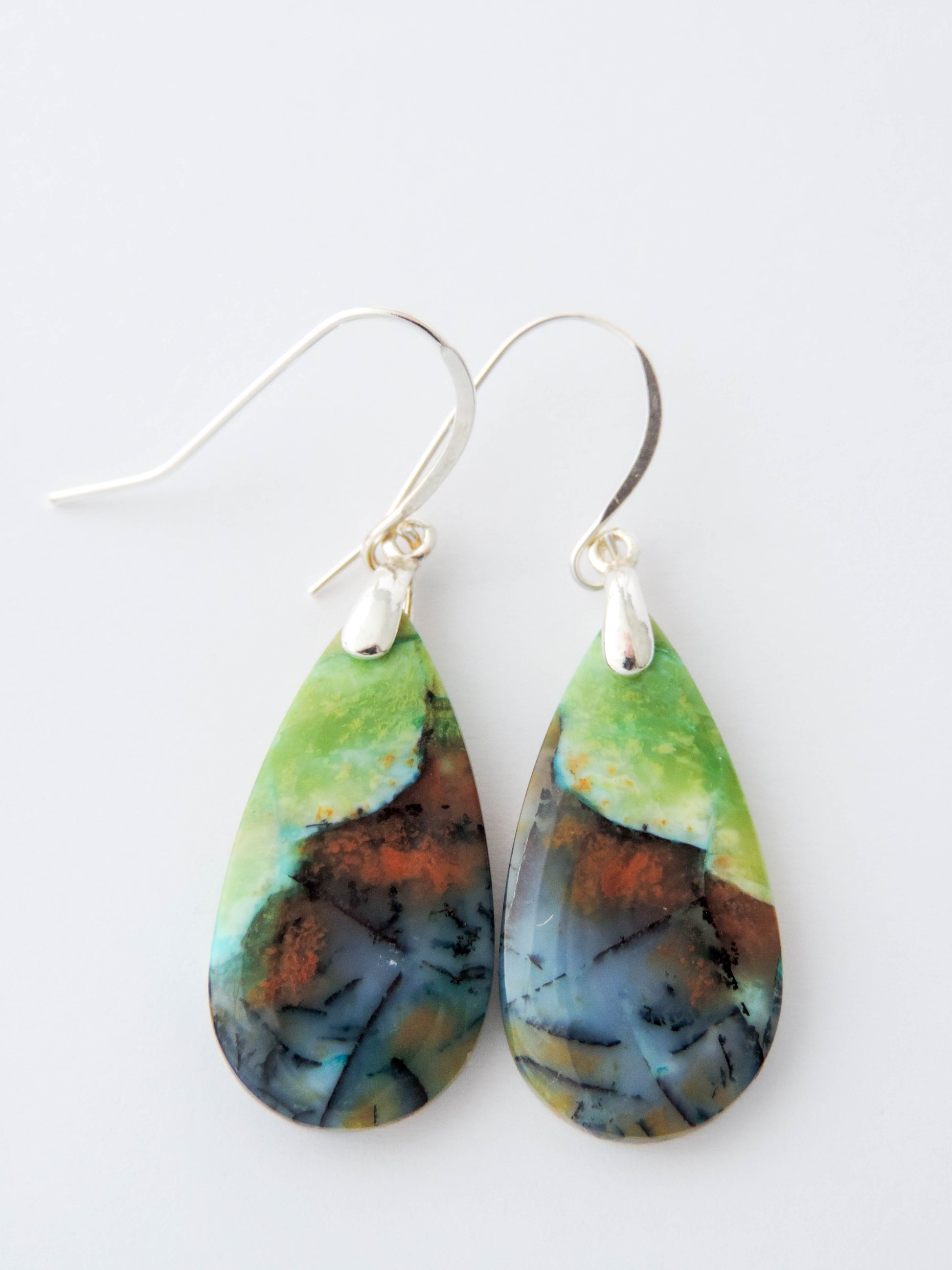 Extremely rare and lovely, Indonesian Blue Opalized Wood is a cherished material used by lapidary artists for creating stunning pieces of jewelry.  The material was first found as pebbles and rounded stones in streams and near the slopes of three volcanoes in the West Java Province.  The bail and earring wires are authentic 925 sterling silver.  Feel treasured when you wear these earrings!