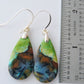 Extremely rare and lovely, Indonesian Blue Opalized Wood is a cherished material used by lapidary artists for creating stunning pieces of jewelry.  The material was first found as pebbles and rounded stones in streams and near the slopes of three volcanoes in the West Java Province.  The bail and earring wires are authentic 925 sterling silver.  Feel treasured when you wear these earrings!