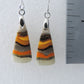 Bumblebee Jasper is named for its yellow, white, orange and black colored banding which resembles a common bumblebee.  This mineral was discovered in the Papandayan Volcano, West Java Province, Indonesia.  The gemstone is truly unique in appearance, fun to wear and is known spiritually for its uplifting, radiant energy.  Bee the buzz when you wear these fun earrings!  The bail and earring wire are authentic 925 sterling silver.