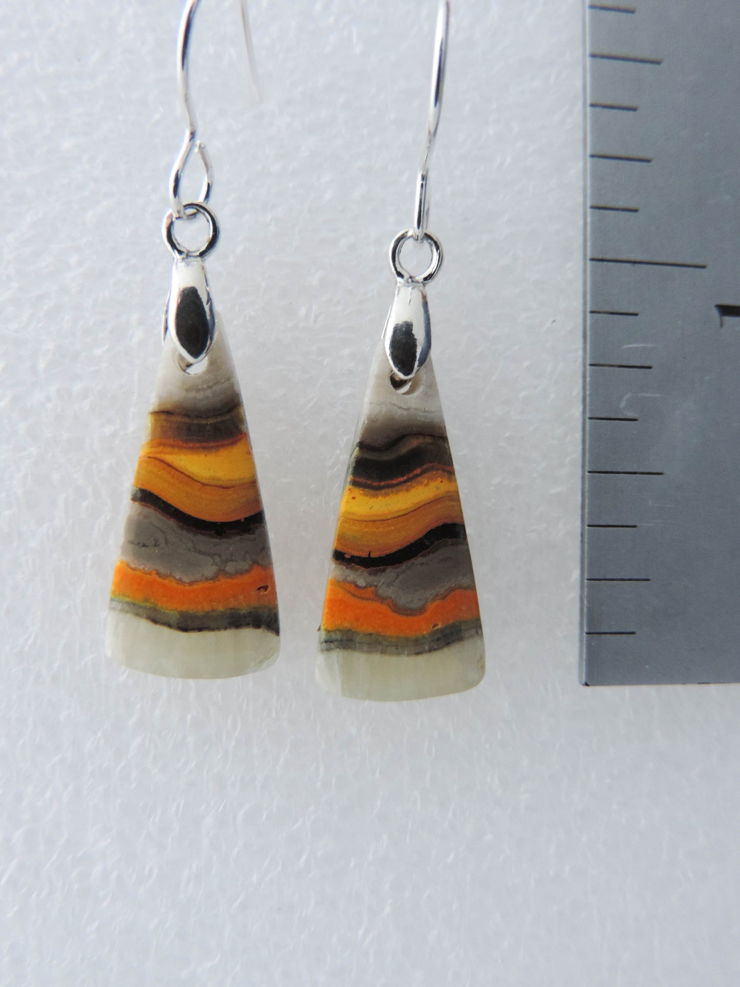 Bumblebee Jasper is named for its yellow, white, orange and black colored banding which resembles a common bumblebee.  This mineral was discovered in the Papandayan Volcano, West Java Province, Indonesia.  The gemstone is truly unique in appearance, fun to wear and is known spiritually for its uplifting, radiant energy.  Bee the buzz when you wear these fun earrings!  The bail and earring wire are authentic 925 sterling silver.