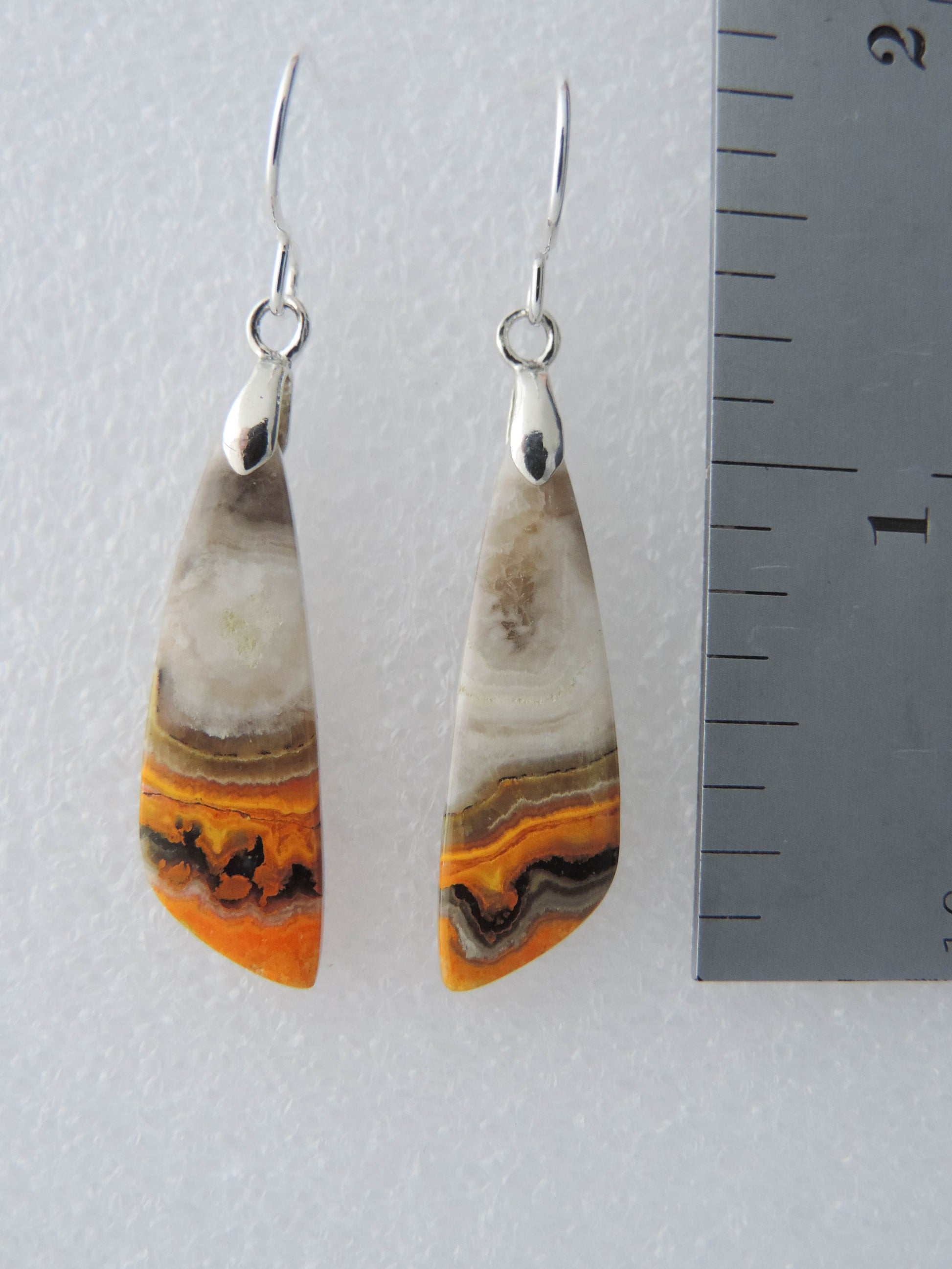 Bumblebee Jasper is named for its yellow, white, orange and black colored banding which resembles a common bumblebee.  This mineral was discovered in the Papandayan Volcano, West Java Province, Indonesia.  The gemstone is truly unique in appearance, fun to wear and is known spiritually for its uplifting, radiant energy.  Bee the buzz when you wear these fun earrings!  The bail and earring wire are authentic 925 sterling silver.