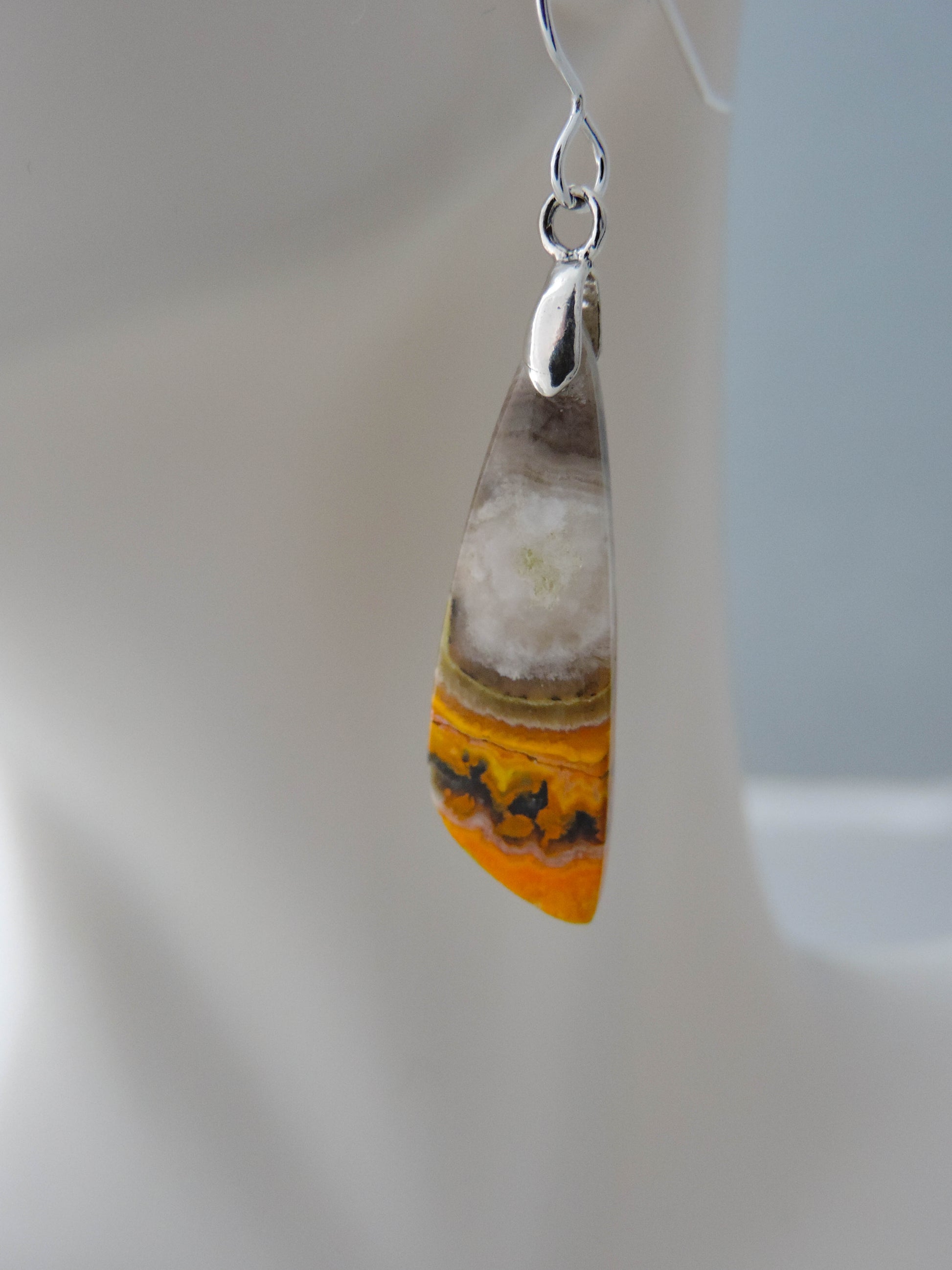 Bumblebee Jasper is named for its yellow, white, orange and black colored banding which resembles a common bumblebee.  This mineral was discovered in the Papandayan Volcano, West Java Province, Indonesia.  The gemstone is truly unique in appearance, fun to wear and is known spiritually for its uplifting, radiant energy.  Bee the buzz when you wear these fun earrings!  The bail and earring wire are authentic 925 sterling silver.