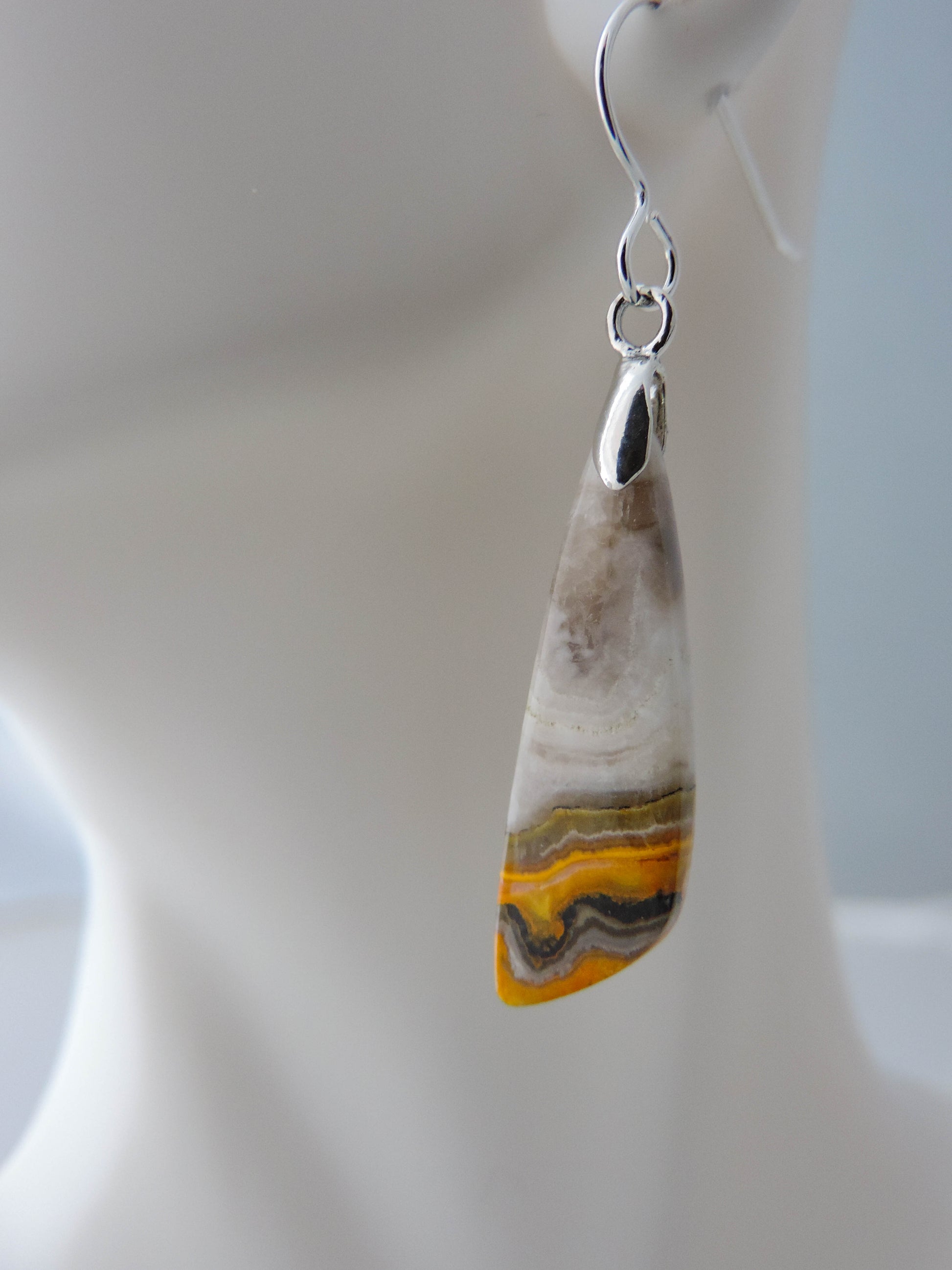 Bumblebee Jasper is named for its yellow, white, orange and black colored banding which resembles a common bumblebee.  This mineral was discovered in the Papandayan Volcano, West Java Province, Indonesia.  The gemstone is truly unique in appearance, fun to wear and is known spiritually for its uplifting, radiant energy.  Bee the buzz when you wear these fun earrings!  The bail and earring wire are authentic 925 sterling silver.