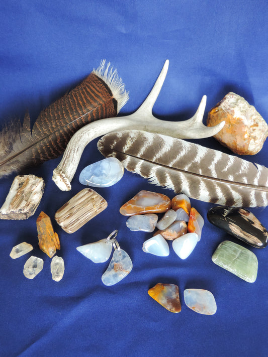 Yellowstone Country Treasure Sampler.  4 crystals, $2.00  1 large chunk polished madison blue agate, $6.00  9 assorted sizes polished madison blue agate, $19.00  1 rough petrified wood, $2.00  1 rough jasper, $4.00  2 madison blue agate key chains, $13.98  2 worry stones, $8.00  2 turkey feathers, $4.00  Total Value... $107.97  Holiday Sale Price - $64.99 (40% off) 