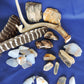 Yellowstone Country Treasure Sampler.  Natural earth items in this sampler package include:  1 antler, $36.99  2 polished petrified wood, $6.00  3 crystals, $1.50  8 assorted sizes polished madison blue agate, $16.00  3 rough petrified wood, $9.00  1 rough madison blue agate, $2.00  2 madison blue agate key chains, $13.98  2 worry stones, $8.00  2 turkey feathers, $4.00  Total Value... $97.47  Holiday Sale Price - $57.99 (40% off)