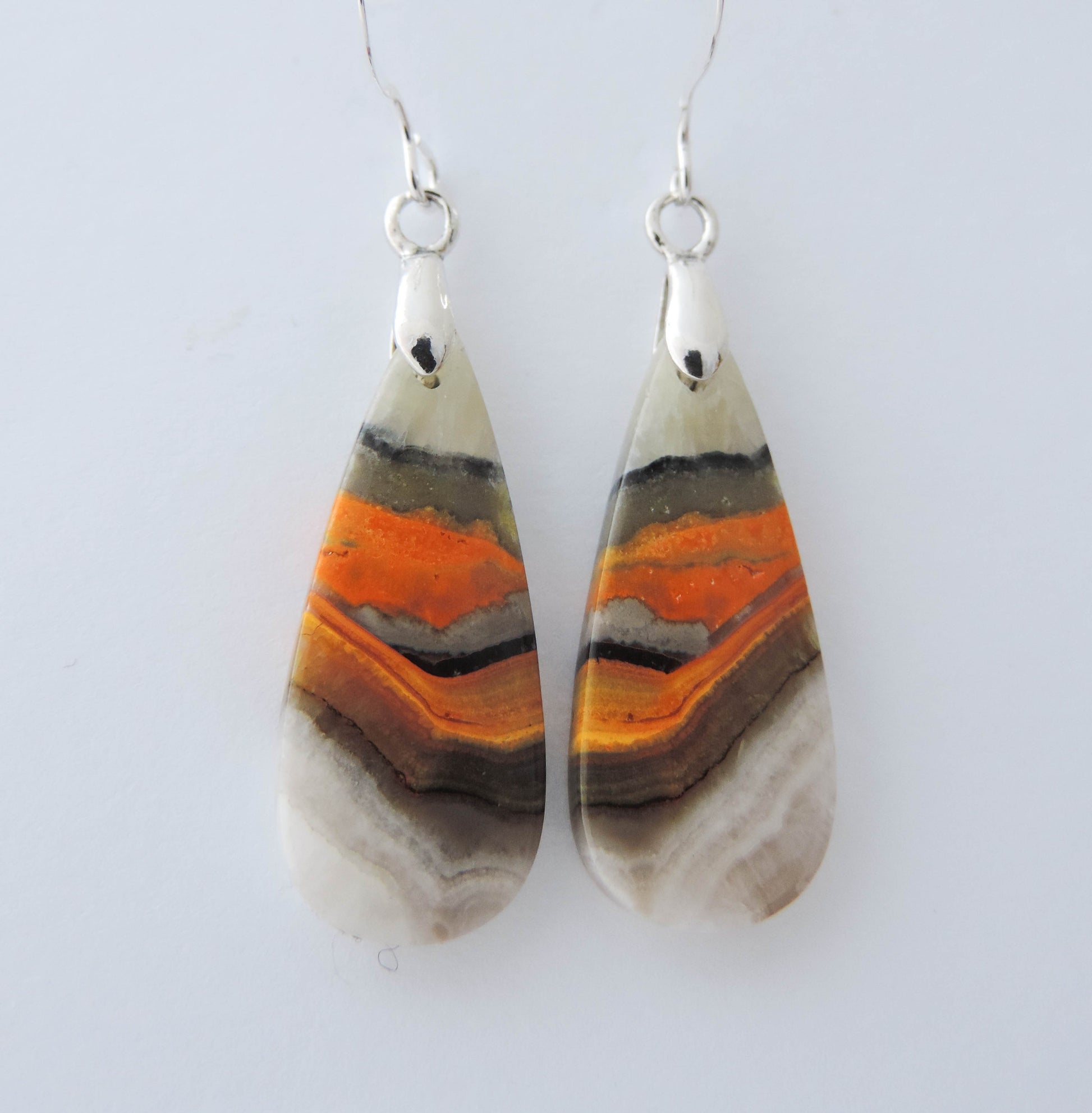 Bumblebee Jasper is named for its yellow, white, orange and black colored banding which resembles a common bumblebee.  This mineral was discovered in the Papandayan Volcano, West Java Province, Indonesia.  The gemstone is truly unique in appearance, fun to wear and is known spiritually for its uplifting, radiant energy.  Bee the buzz when you wear these fun earrings!  The bail and earring wire are authentic 925 sterling silver.