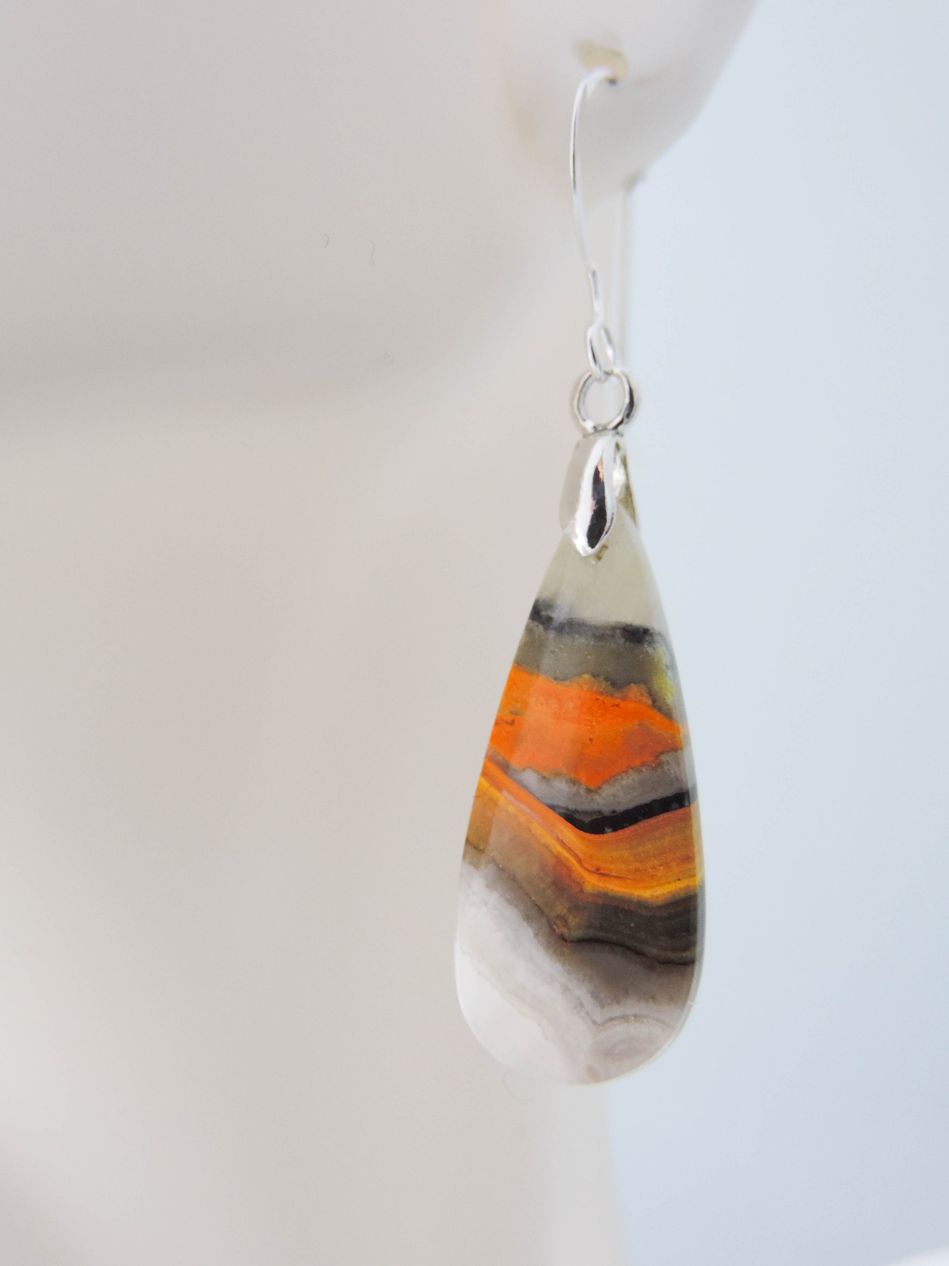 Bumblebee Jasper is named for its yellow, white, orange and black colored banding which resembles a common bumblebee.  This mineral was discovered in the Papandayan Volcano, West Java Province, Indonesia.  The gemstone is truly unique in appearance, fun to wear and is known spiritually for its uplifting, radiant energy.  Bee the buzz when you wear these fun earrings!  The bail and earring wire are authentic 925 sterling silver.