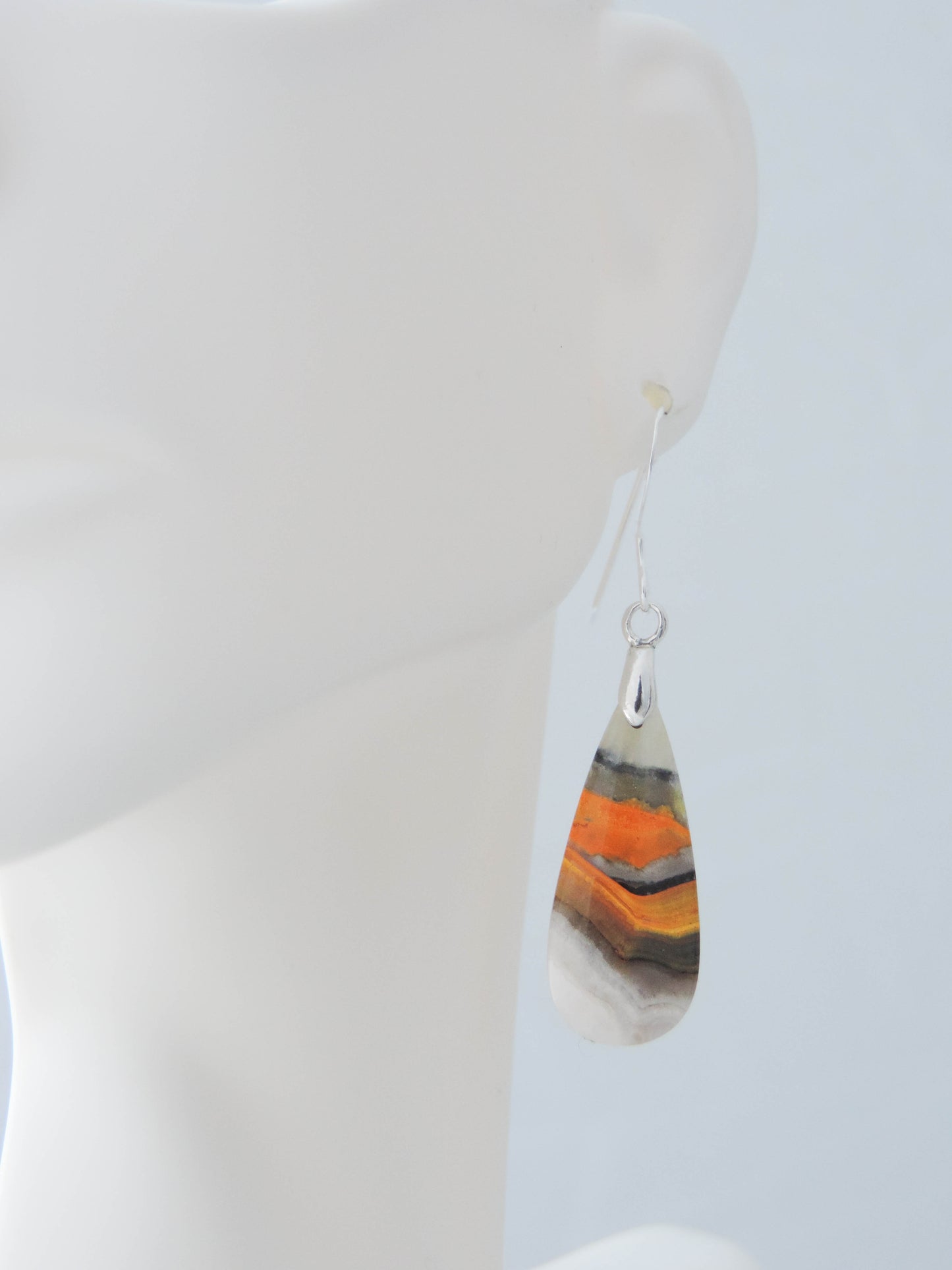 Bumblebee Jasper is named for its yellow, white, orange and black colored banding which resembles a common bumblebee.  This mineral was discovered in the Papandayan Volcano, West Java Province, Indonesia.  The gemstone is truly unique in appearance, fun to wear and is known spiritually for its uplifting, radiant energy.  Bee the buzz when you wear these fun earrings!  The bail and earring wire are authentic 925 sterling silver.