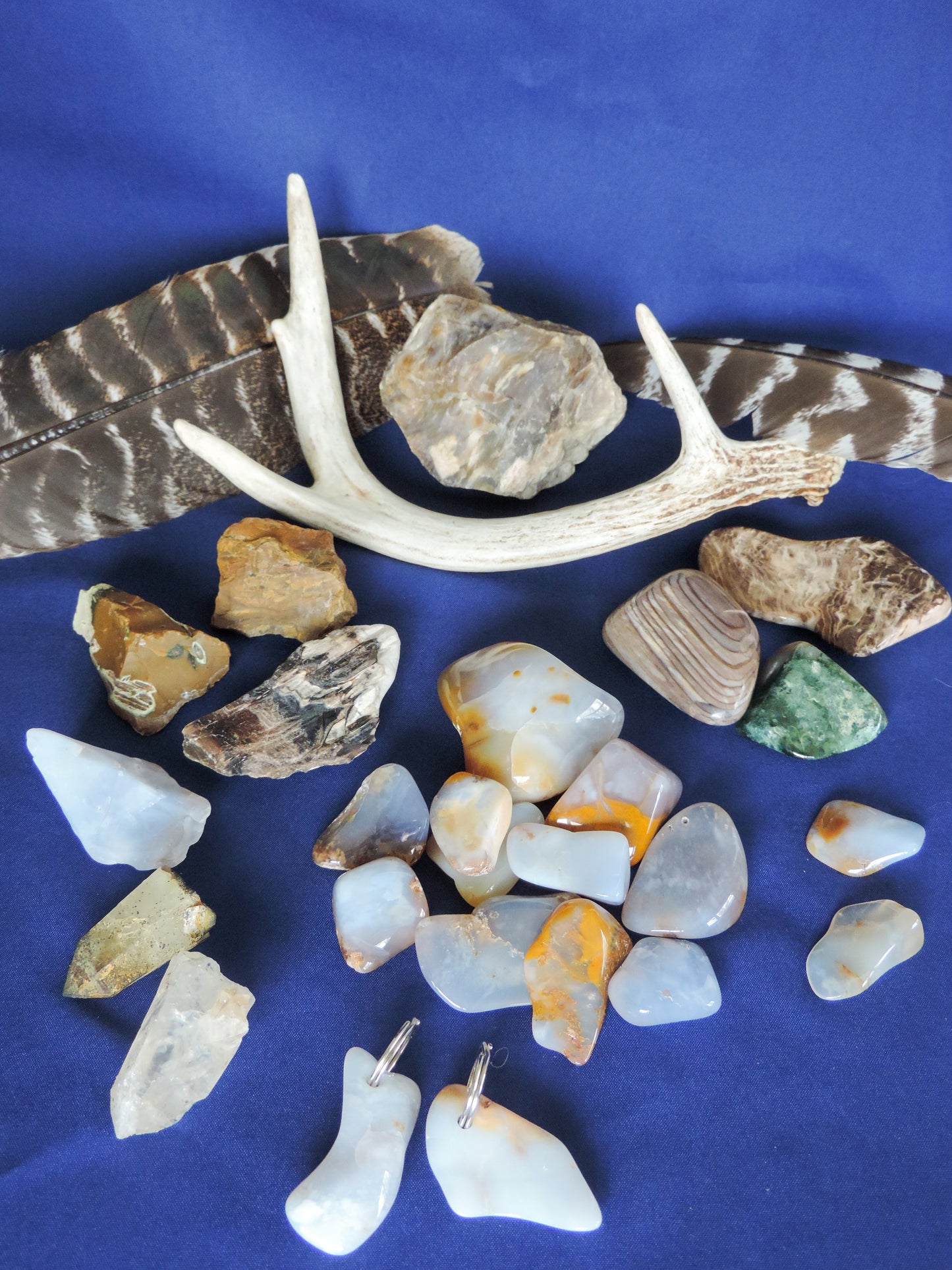 Yellowstone Country Treasure Sampler.  Natural earth items in this sampler package include:  1 antler, $36.99  3 polished petrified wood, $6.00  2 crystals, $1.00  1 large chunk polished madison blue agate, $4.00  10 assorted sizes polished madison blue agate, $20.00  2 rough petrified wood, $5.00  2 rough jasper, $4.00  1 rough madison blue agate, $2.00  2 madison blue agate key chains, $13.98  2 worry stones, $8.00  2 turkey feathers, $4.00  Total Value... $104.97  Holiday Sale Price - $62.99 (40% off)