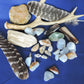 Yellowstone Country Treasure Sampler.  Natural earth items in this sampler package include:  1 antler, $36.99  3 polished petrified wood, $6.00  7 crystals, $3.50  8 assorted sizes polished madison blue agate, $16.00  1 rough petrified wood, $3.00  1 rough jasper, $4.00  2 rough madison blue agate, $4.00  2 madison blue agate key chains, $13.98  2 worry stones, $8.00  2 turkey feathers, $4.00  Total Value... $99.47  Holiday Sale Price - $59.69 (40% off