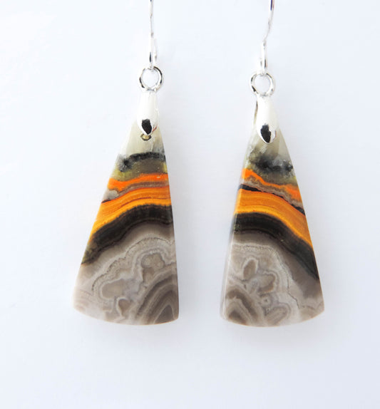 Bumblebee Jasper is named for its yellow, white, orange and black colored banding which resembles a common bumblebee.  This mineral was discovered in the Papandayan Volcano, West Java Province, Indonesia.  The gemstone is truly unique in appearance, fun to wear and is known spiritually for its uplifting, radiant energy.  Bee the buzz when you wear these fun earrings!  The bail and earring wire are authentic 925 sterling silver.