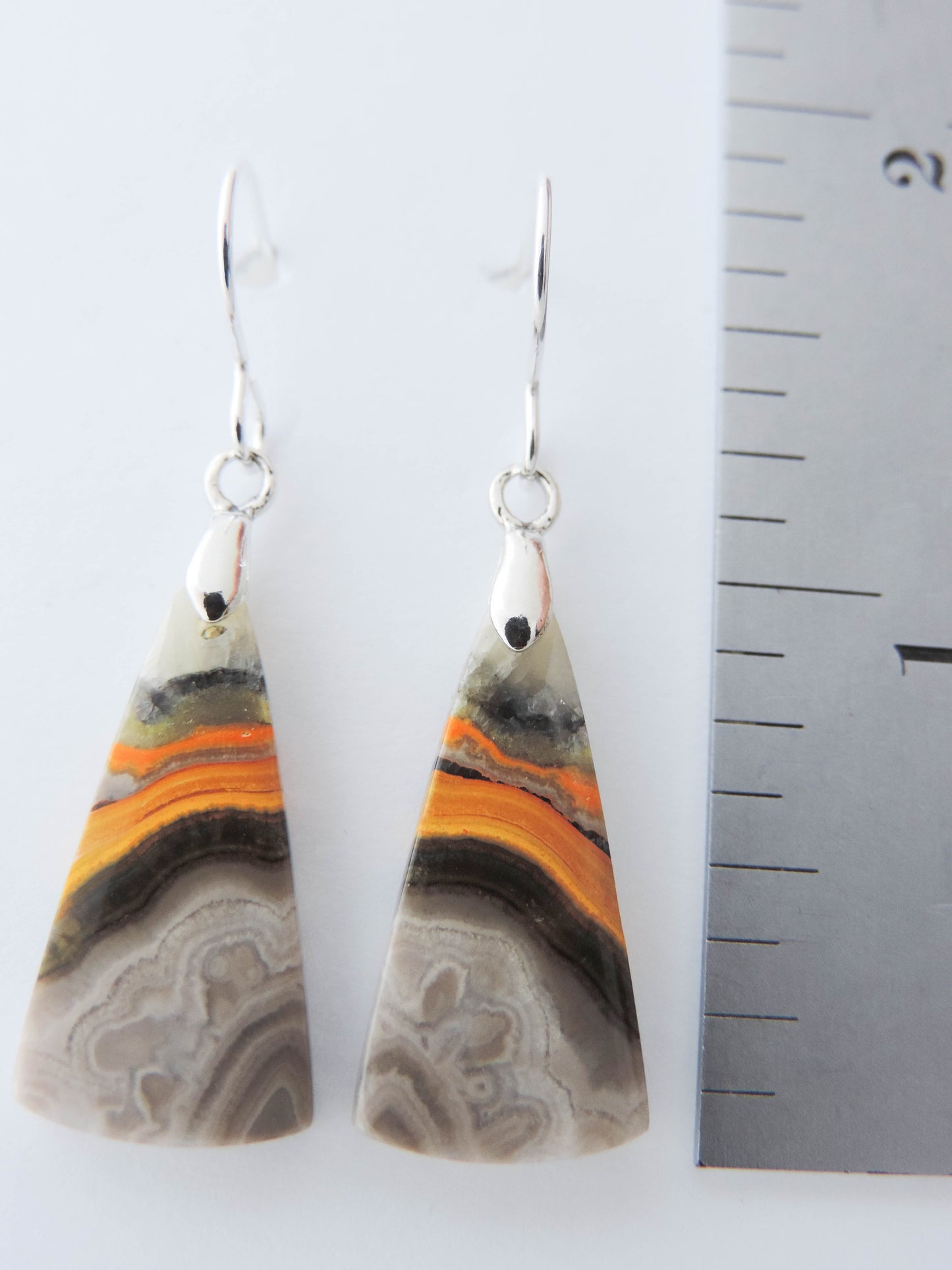 Bumblebee Jasper is named for its yellow, white, orange and black colored banding which resembles a common bumblebee.  This mineral was discovered in the Papandayan Volcano, West Java Province, Indonesia.  The gemstone is truly unique in appearance, fun to wear and is known spiritually for its uplifting, radiant energy.  Bee the buzz when you wear these fun earrings!  The bail and earring wire are authentic 925 sterling silver.