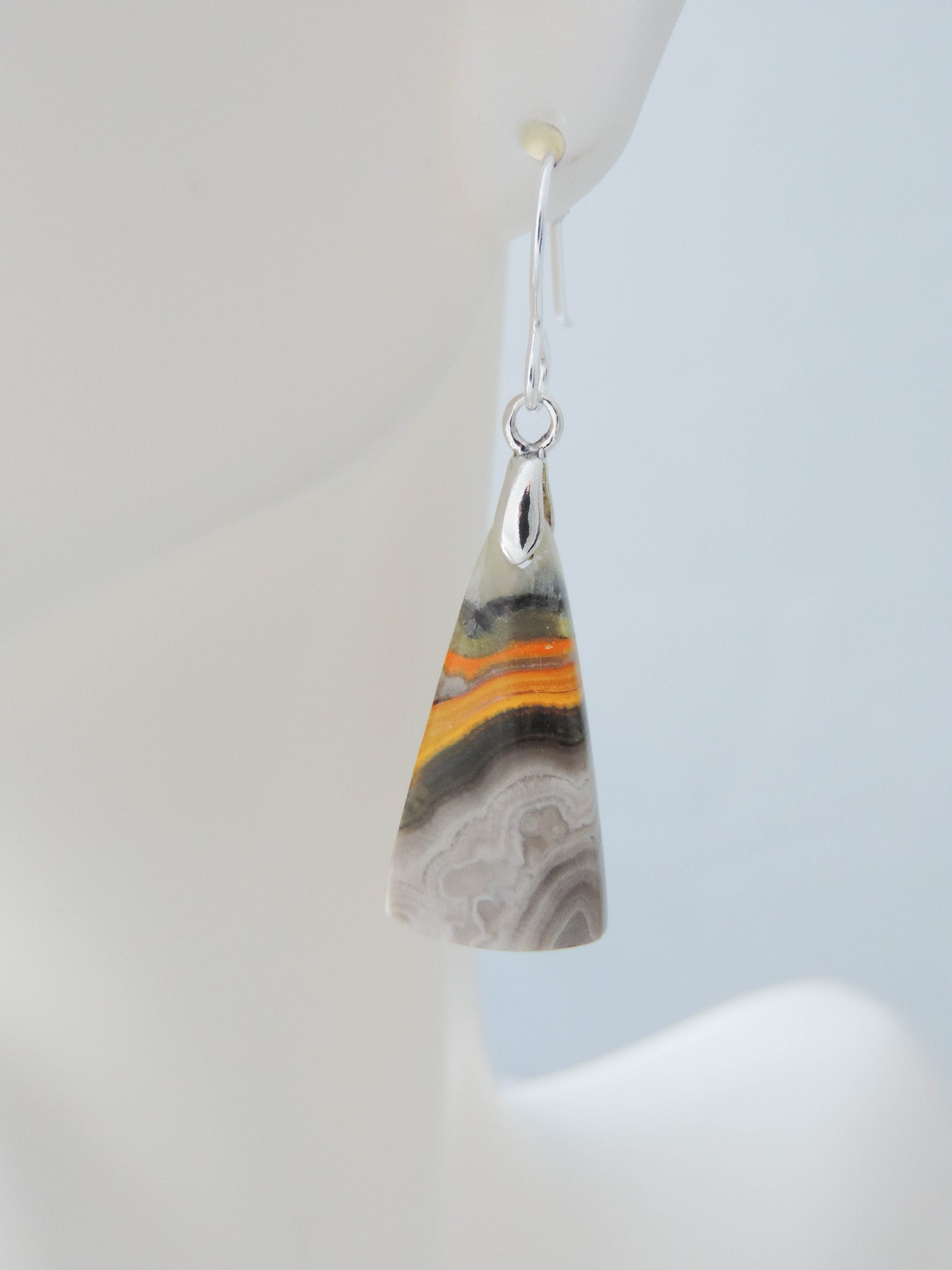 Bumblebee Jasper is named for its yellow, white, orange and black colored banding which resembles a common bumblebee.  This mineral was discovered in the Papandayan Volcano, West Java Province, Indonesia.  The gemstone is truly unique in appearance, fun to wear and is known spiritually for its uplifting, radiant energy.  Bee the buzz when you wear these fun earrings!  The bail and earring wire are authentic 925 sterling silver.