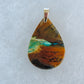 Indonesian Blue Opalized Wood Pendant.  Extremely rare and lovely, Indonesian Blue Opalized Wood is a cherished material used by lapidary artists for creating stunning pieces of jewelry.  This material was first found as pebbles and rounded stones in streams and near the slopes of three volcanoes in the West Java Province.  