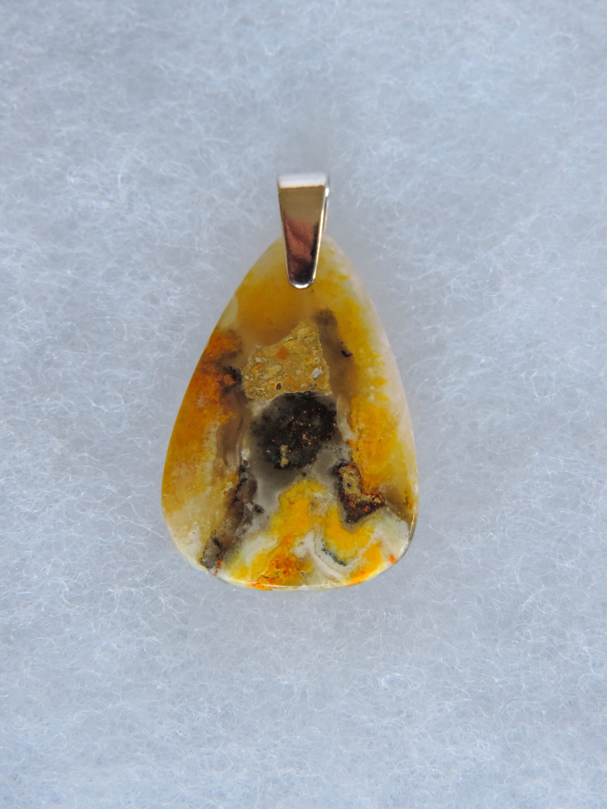 Bumblebee Jasper Pendant.  Bumblebee Jasper is named for its yellow, white, orange and black colored banding which resembles a common bumblebee.  This mineral was discovered in the Papandayan Volcano, West Java Province, Indonesia.  The gemstone is truly unique in appearance, fun to wear and is known spiritually for its uplifting, radiant energy.  Bee the buzz when you wear this fun pendant!