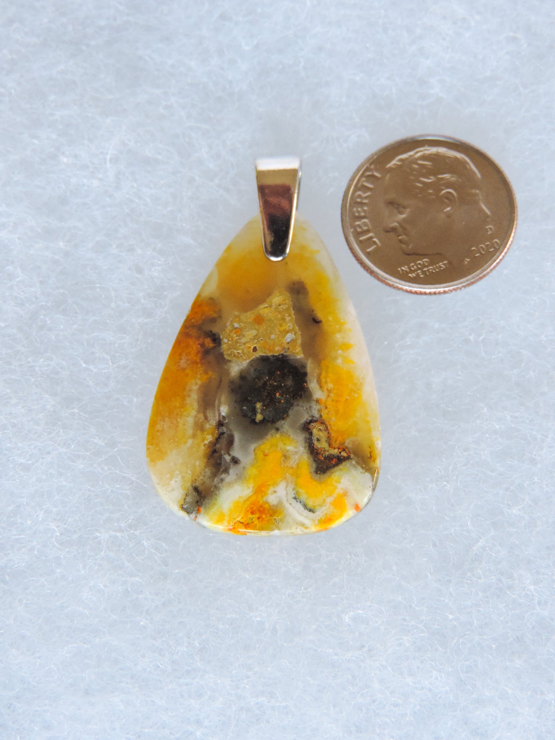 The pendant bail is authentic 925 sterling silver.  This stone is a natural color, no dyes or heat treatment have been used.  It was photographed without filters in natural light; however, slight color variations may occur due to digitization.  Natural stones can have nooks and crannies, inclusions or small cracks, these distinguishing features lend character to the piece.