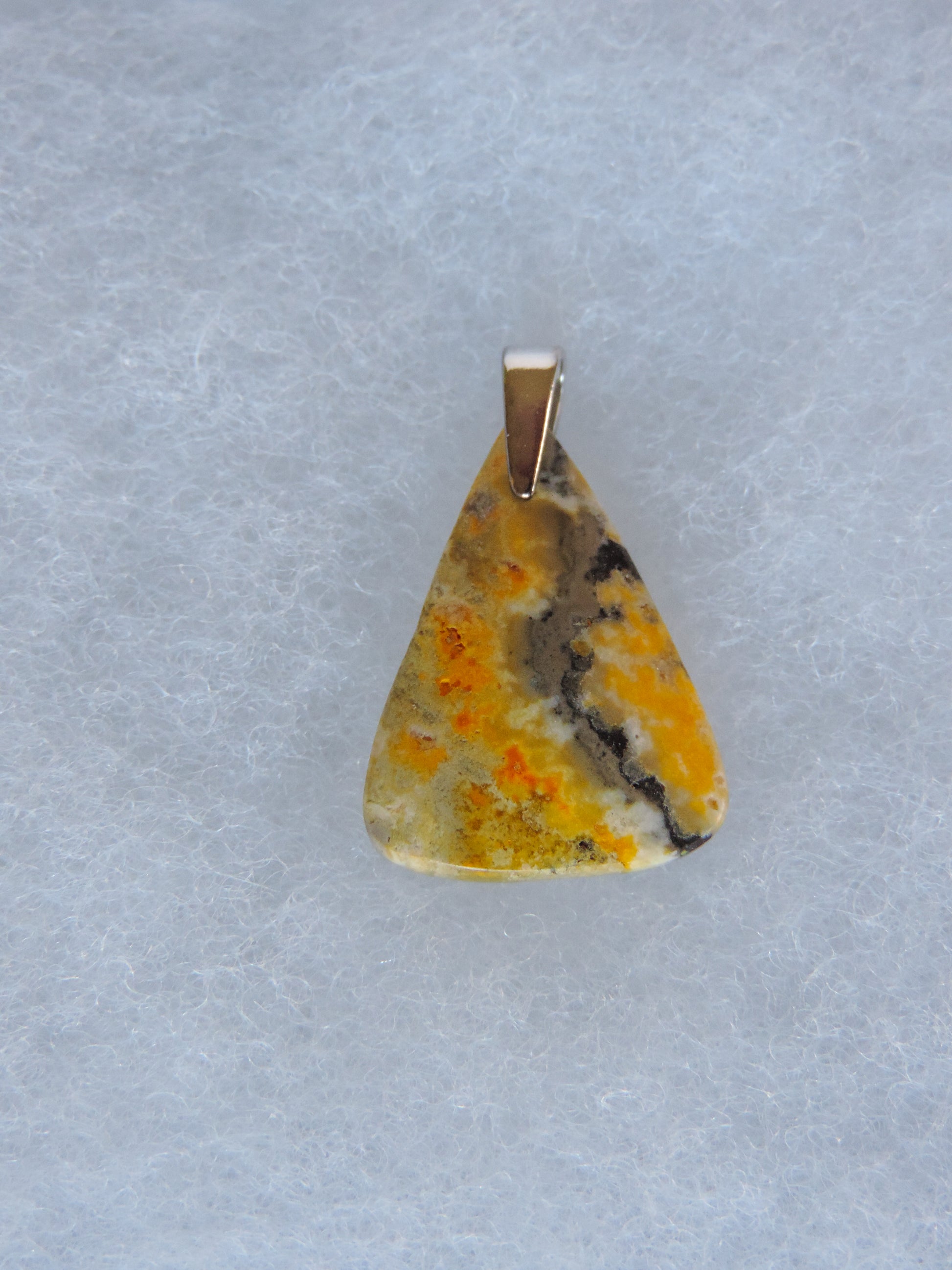 Bumblebee Jasper Pendant.  Bumblebee Jasper is named for its yellow, white, orange and black colored banding which resembles a common bumblebee.  This mineral was discovered in the Papandayan Volcano, West Java Province, Indonesia.  The gemstone is truly unique in appearance, fun to wear and is known spiritually for its uplifting, radiant energy.   Bee the buzz when you wear this fun pendant!