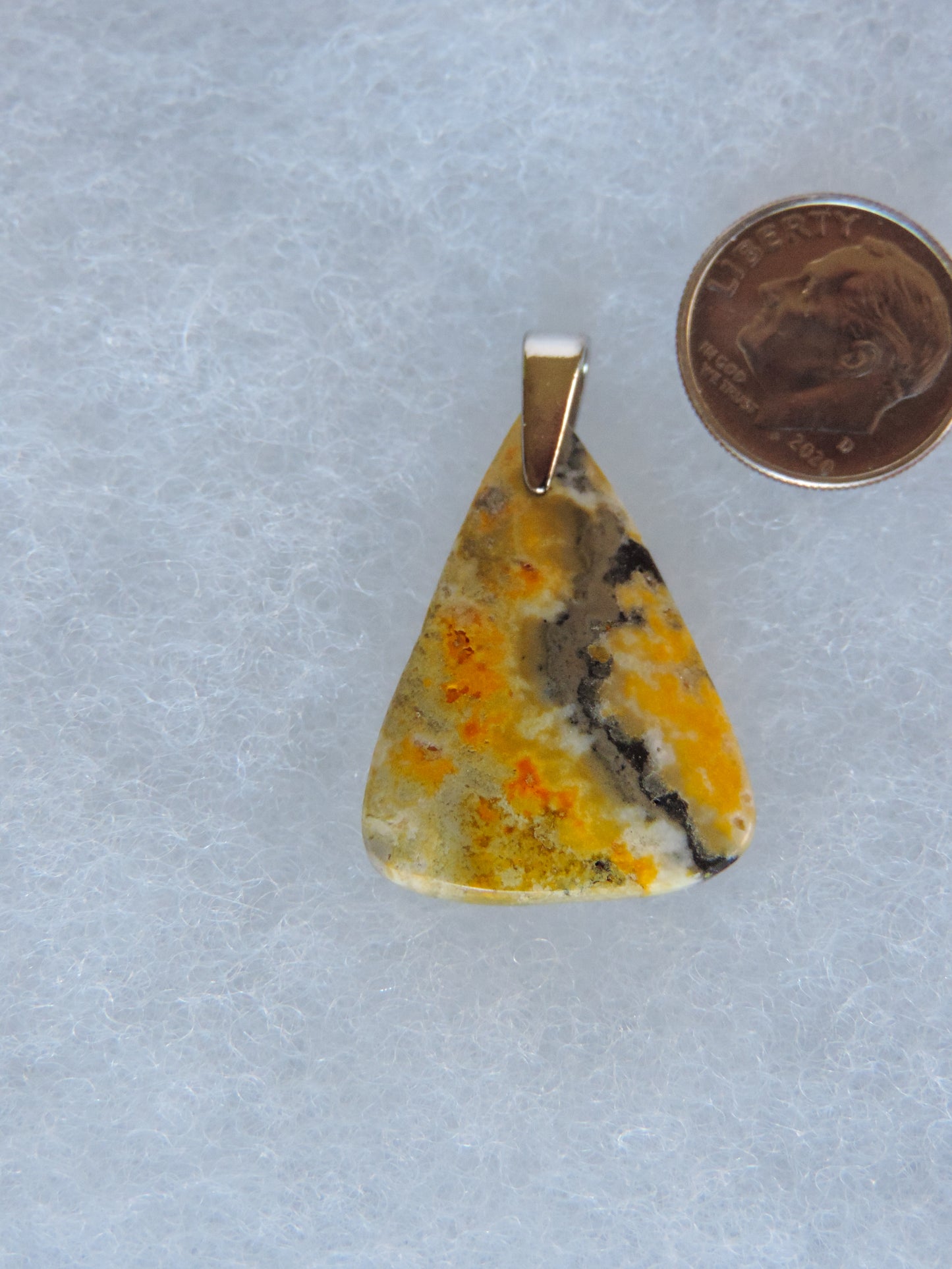 The pendant bail is authentic 925 sterling silver.  This stone is a natural color, no dyes or heat treatment have been used.  It was photographed without filters in natural light; however, slight color variations may occur due to digitization