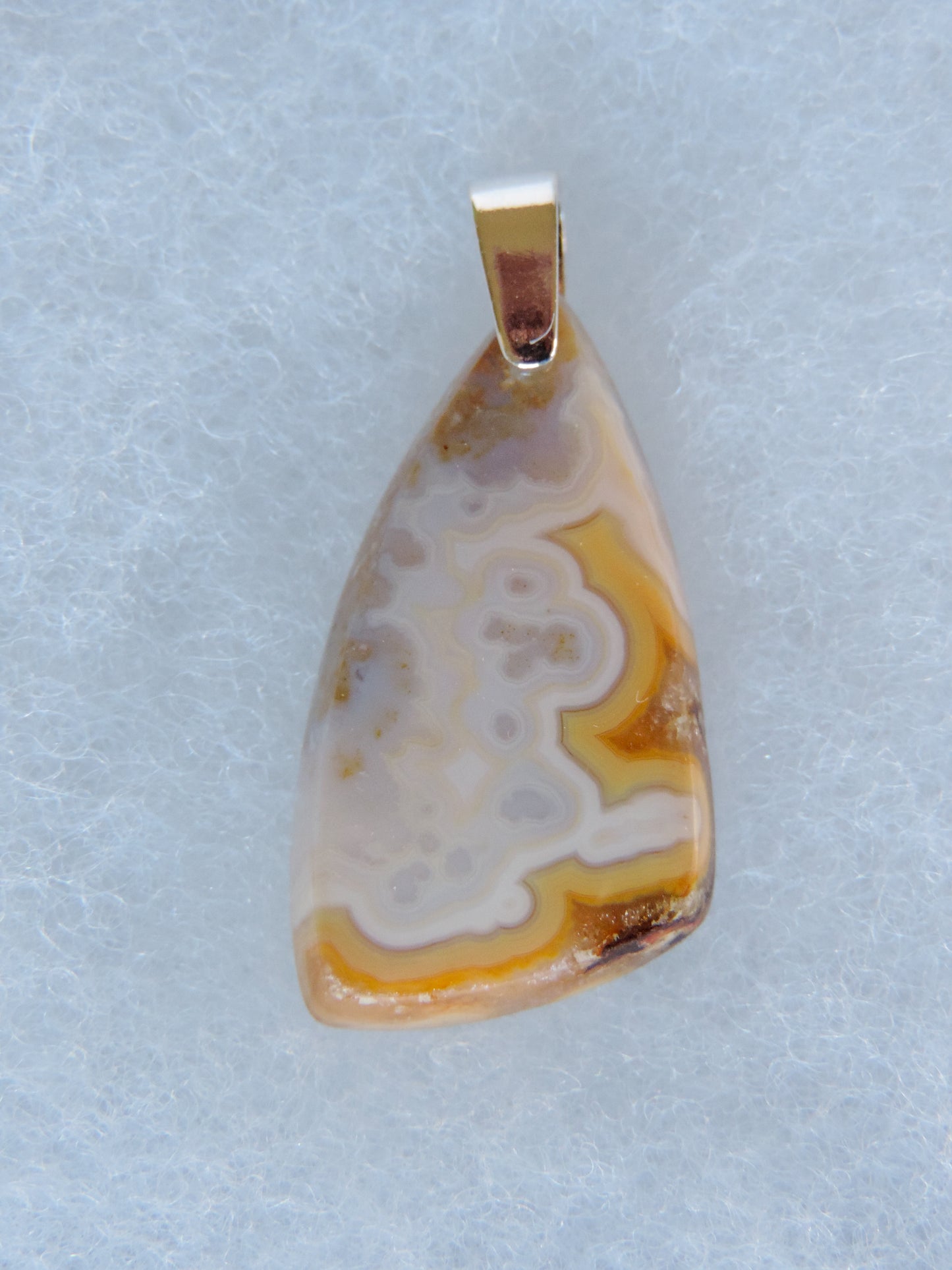 Brown Lace Agate Pendant  Indonesian Agates exhibit a wide variety of colors and amazing complexity.  No two agates are exactly alike, each one being a unique and beautiful creation!  Agates with multiple bands of color are known as fortification agates, those with dendritic or moss looking inclusions are referred to as moss agate and many others are given descriptive names relative to their appearance or where they are found.  The diversity and complexity of 