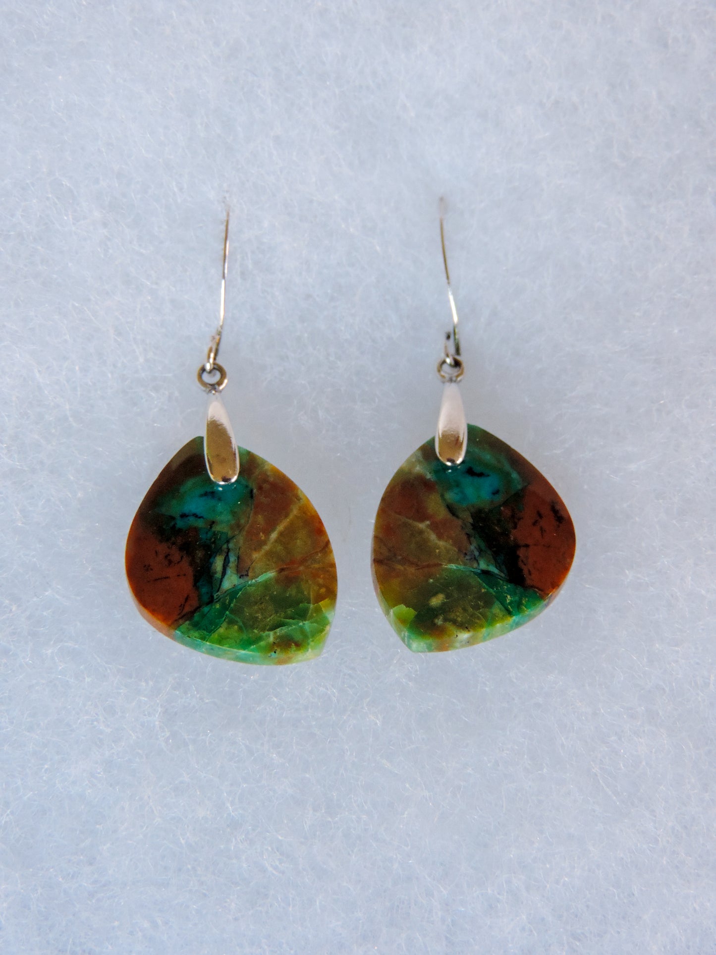 This stone is a natural color, no dyes or heat treatment have been used.  It was photographed without filters in natural light; however, slight color variations may occur due to digitization.  Natural stones can have nooks and crannies, inclusions or small cracks, these distinguishing features lend character to the piece.  Your Blue Opalized Wood Earrings